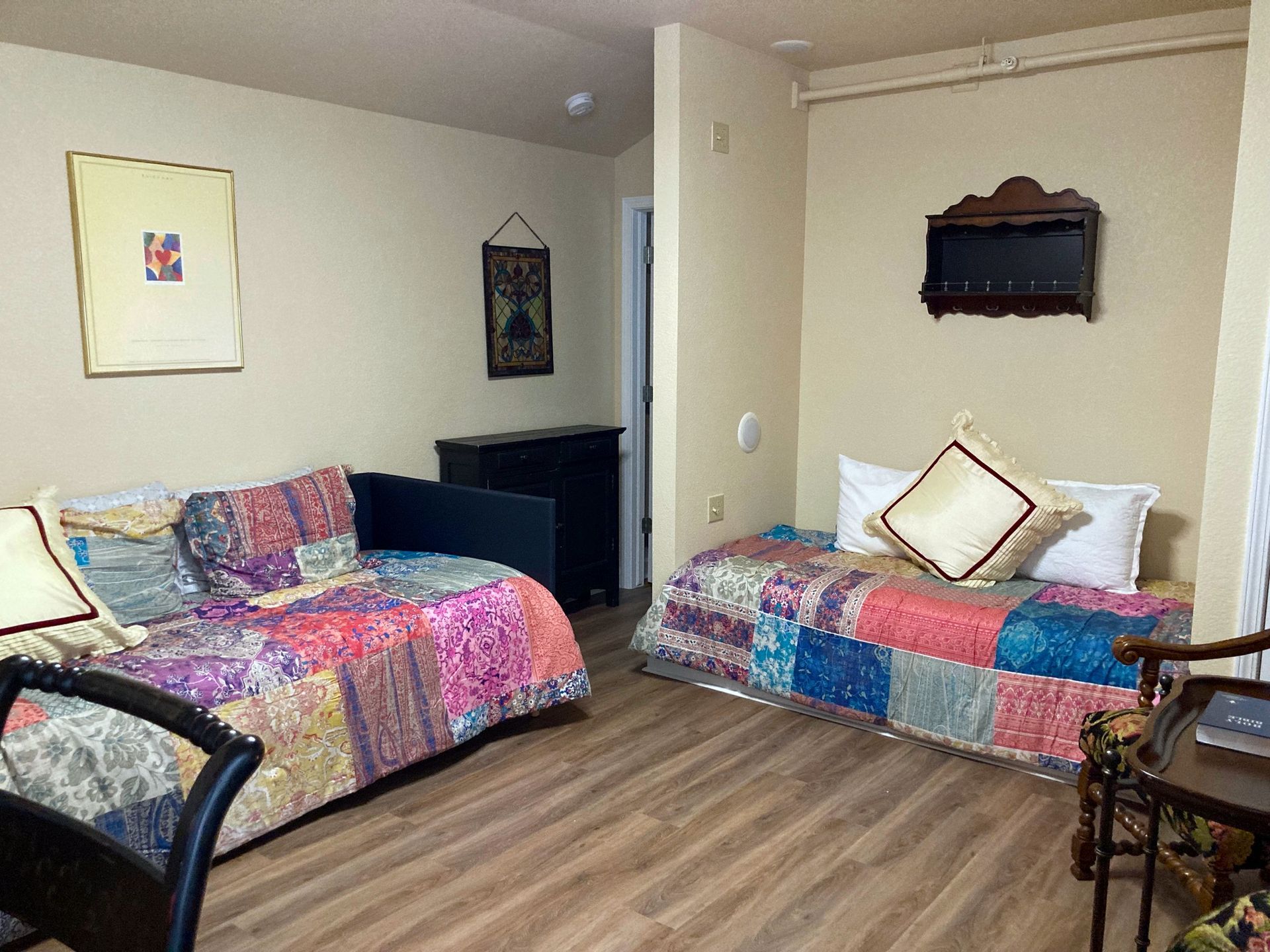 A bedroom with two beds , a couch and a chair.