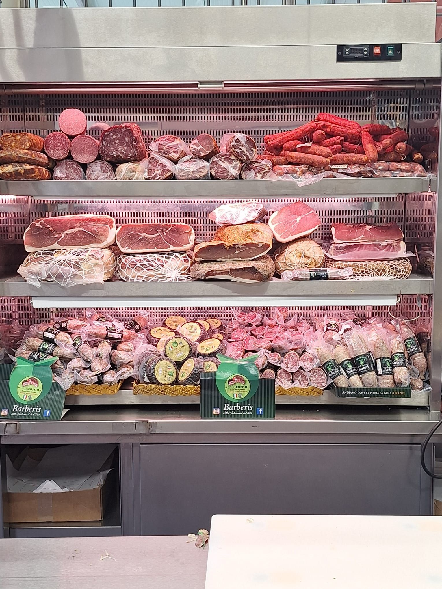 Una vetrina piena di una varietà di carni e verdure.