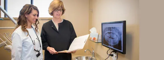 Two women looking at the dental records — Clinton TWP, MI — Baker & Ochs Family Dentistry