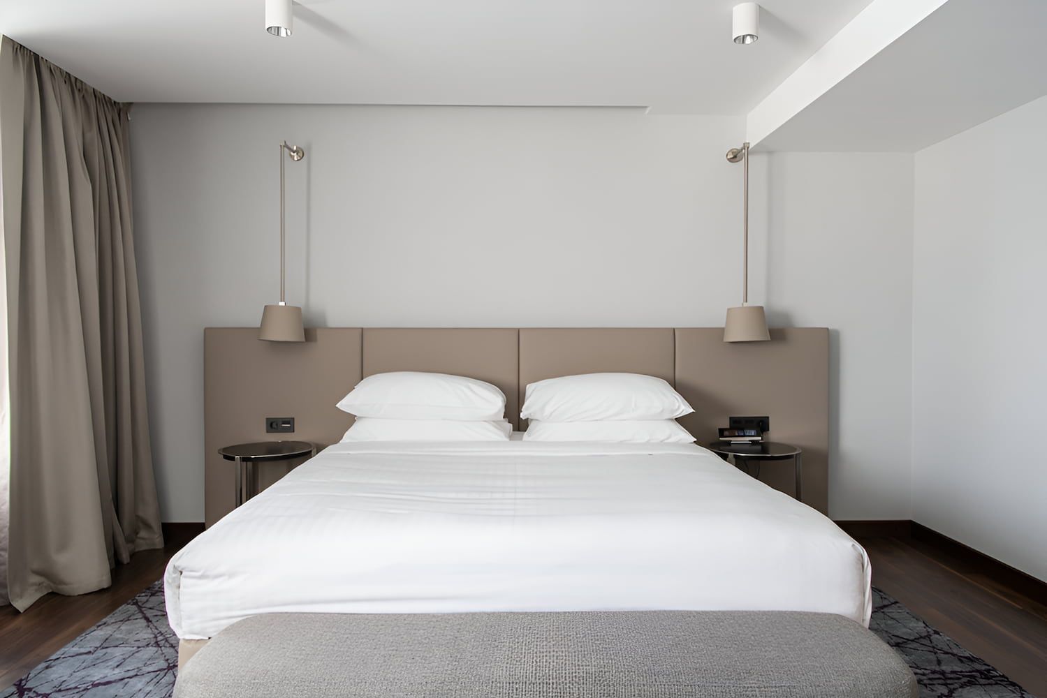 A Hotel Room With a Large Bed and a Bench — Bryants Beds and Mattresses In Lismore, NSW