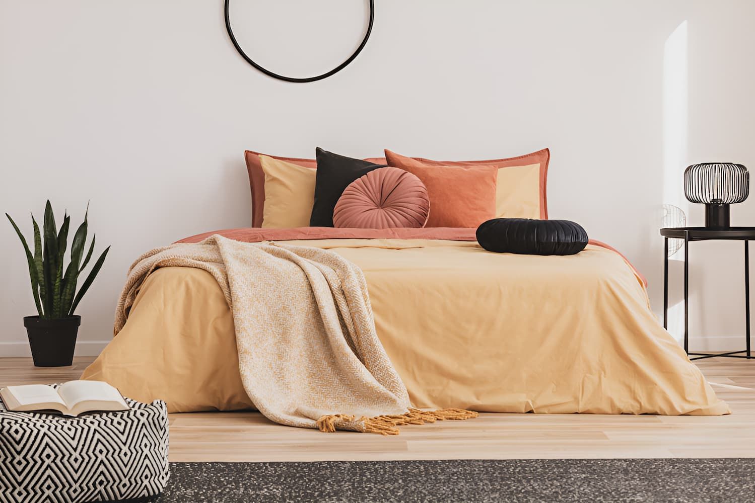 A Bed With a Yellow Comforter and Pillows in a Bedroom — Bryants Beds and Mattresses In Lismore, NSW
