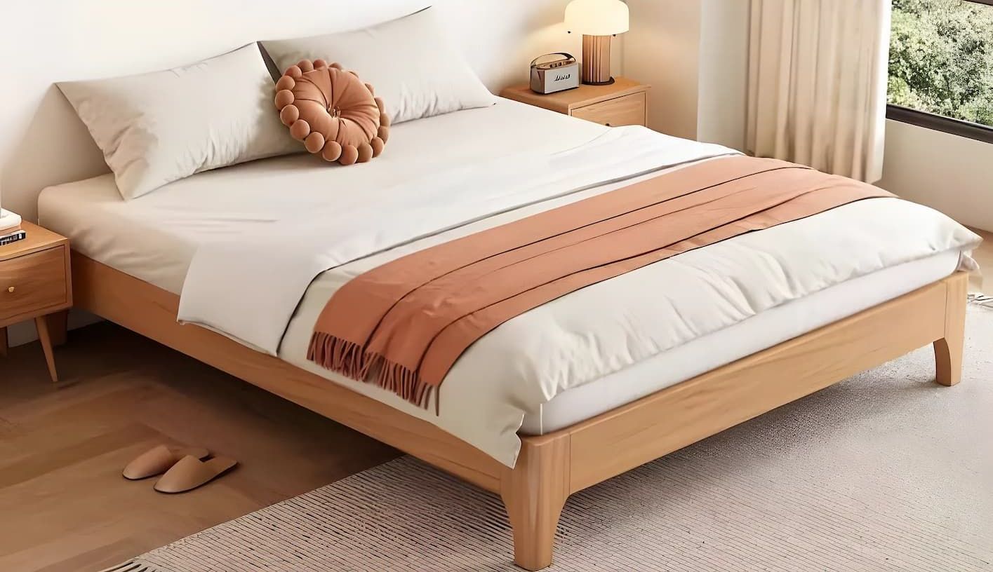 A Bed With a Wooden Frame and White Sheets is Sitting in a Bedroom — Bryants Beds and Mattresses In Lismore, NSW