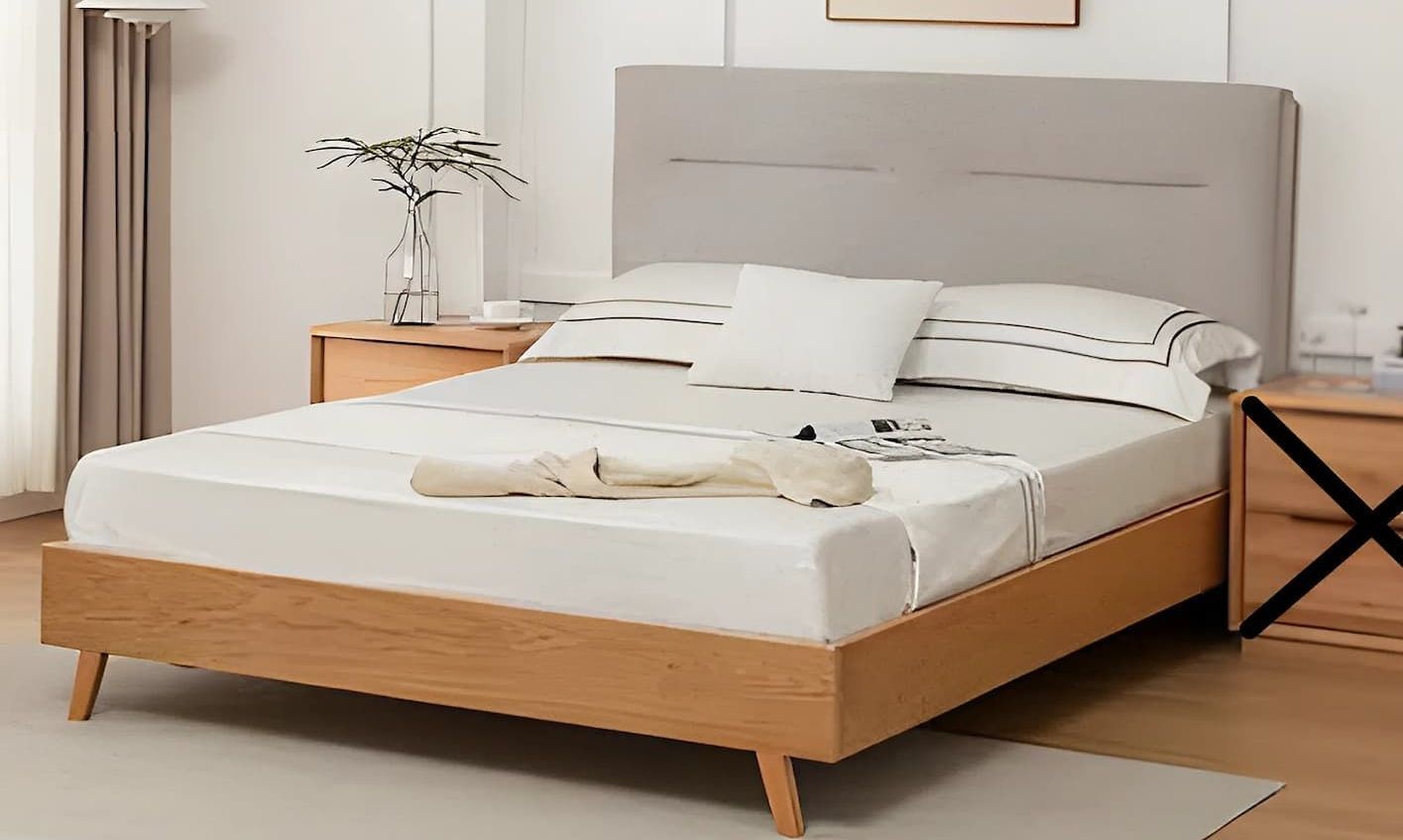 A Bed With a Mattress and Pillows in a Bedroom — Bryants Beds and Mattresses In Lismore, NSW