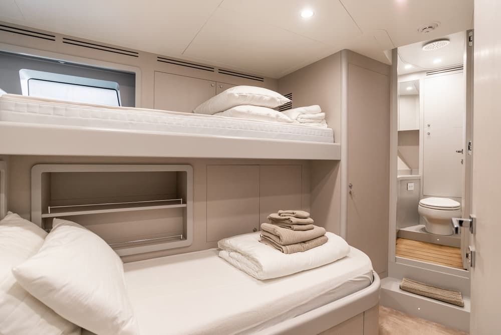 A Bedroom on a Boat With Two Bunk Beds and a Toilet — Bryants Beds and Mattresses In Lismore, NSW
