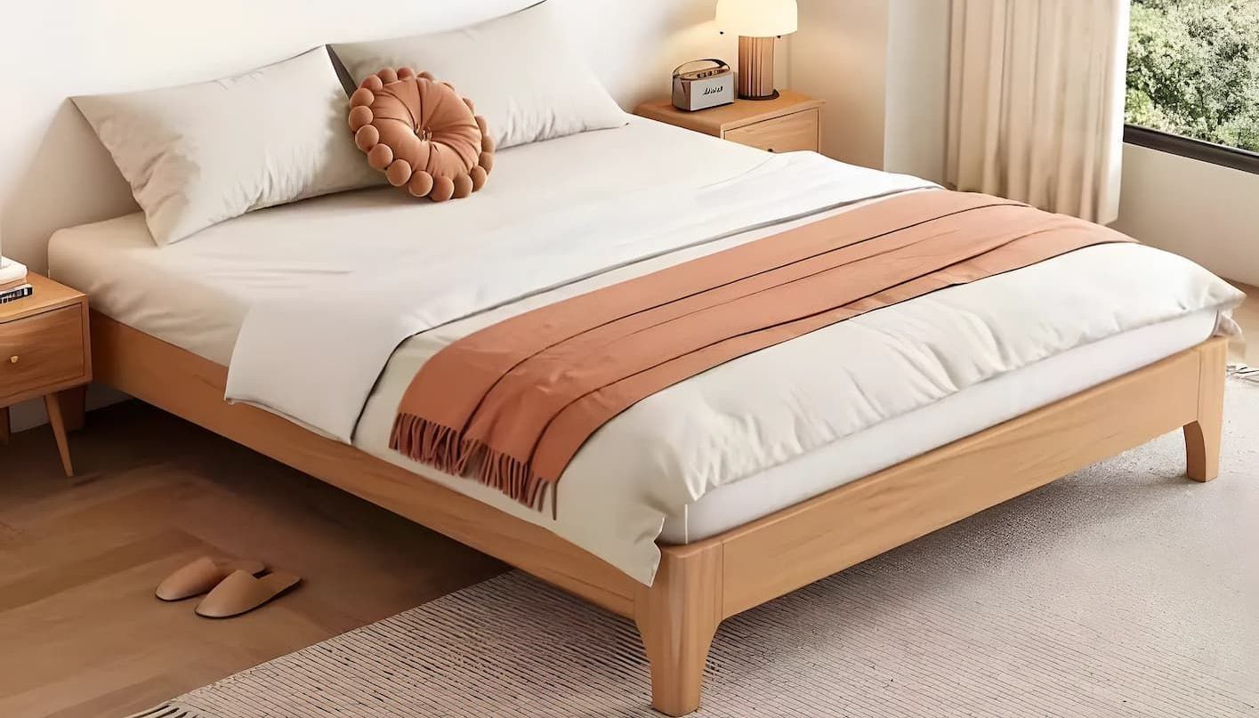 A Bed With a Wooden Frame and White Sheets is Sitting in a Bedroom — Bryants Beds and Mattresses In Lismore, NSW