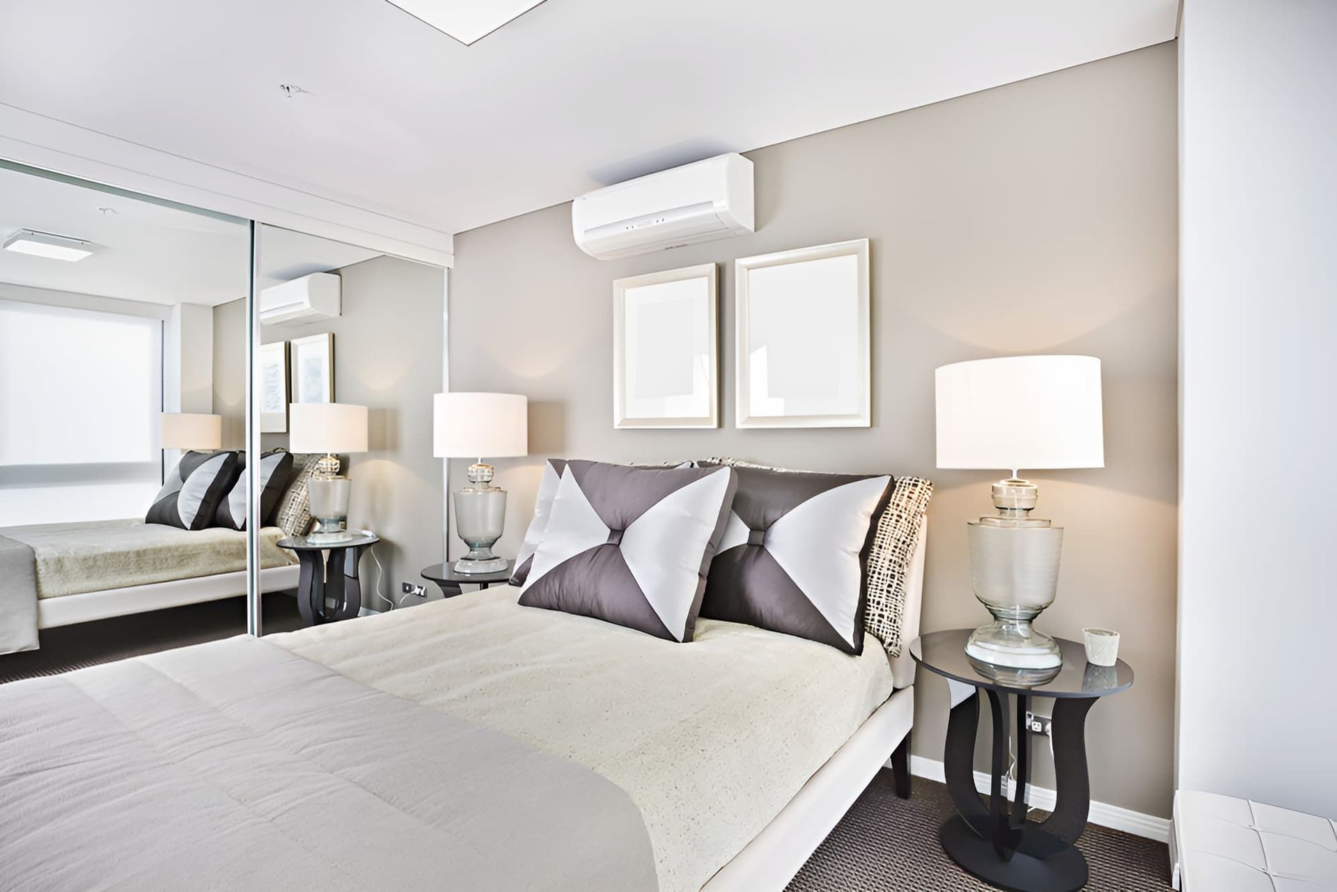 A Bedroom With a Bed, Lamps and Mirrors — Bryants Beds and Mattresses In Lismore, NSW