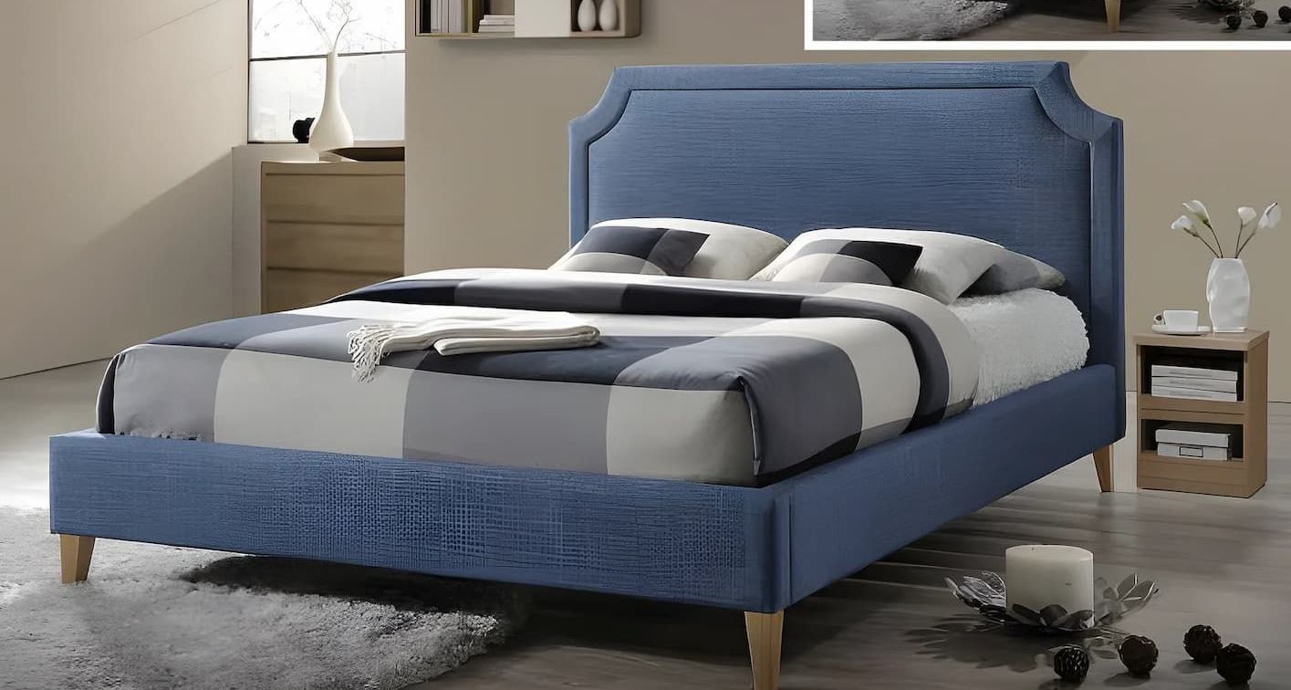 A Bed With a Blue Headboard is Sitting in a Bedroom — Bryants Beds and Mattresses In Lismore, NSW