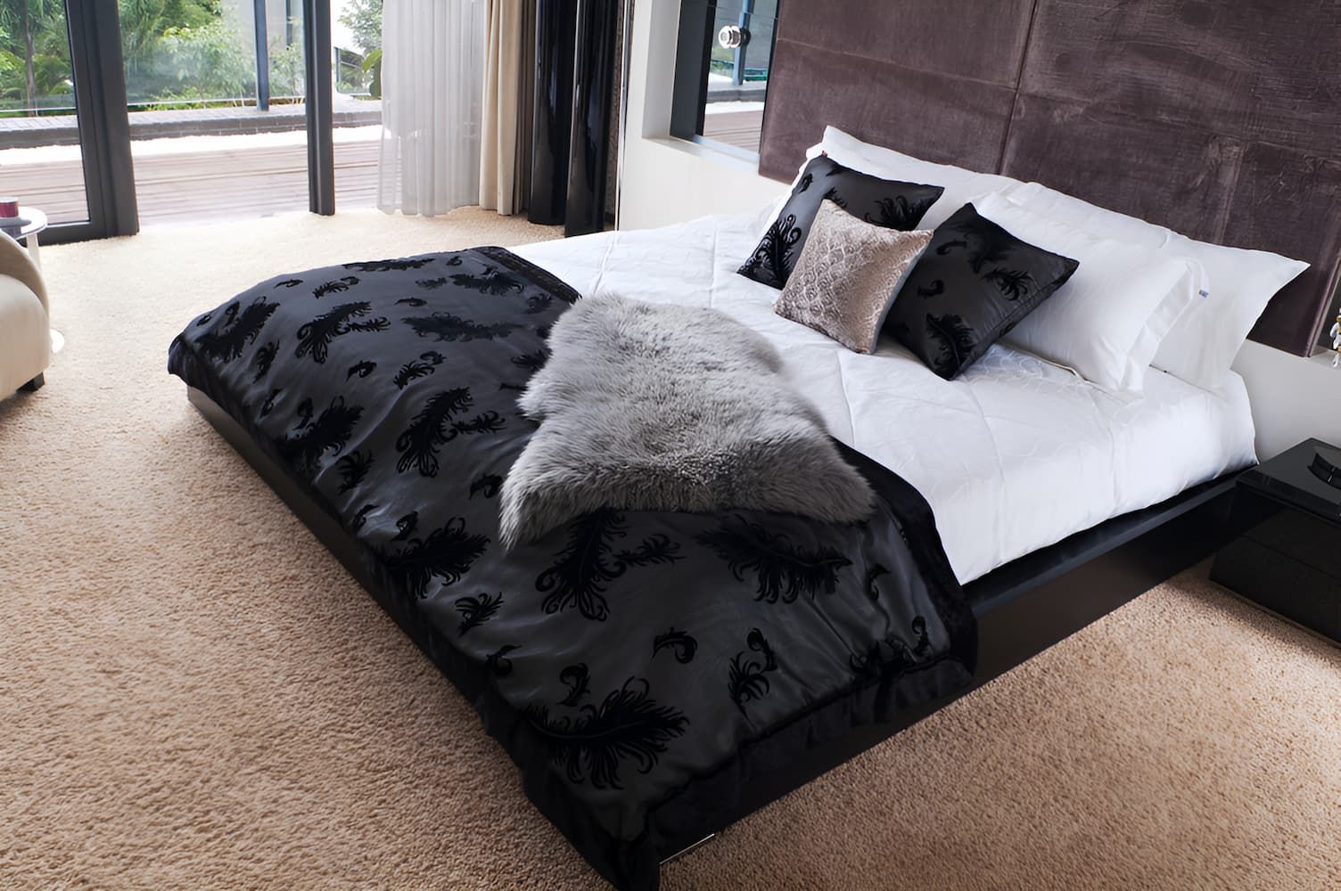A Bed With a Black and White Comforter and Pillows — Bryants Beds and Mattresses In Lismore, NSW