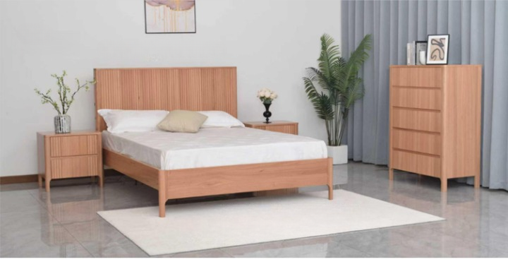 Bedroom set with a wooden bed, nightstands, and dresser in a neutral-colored room.