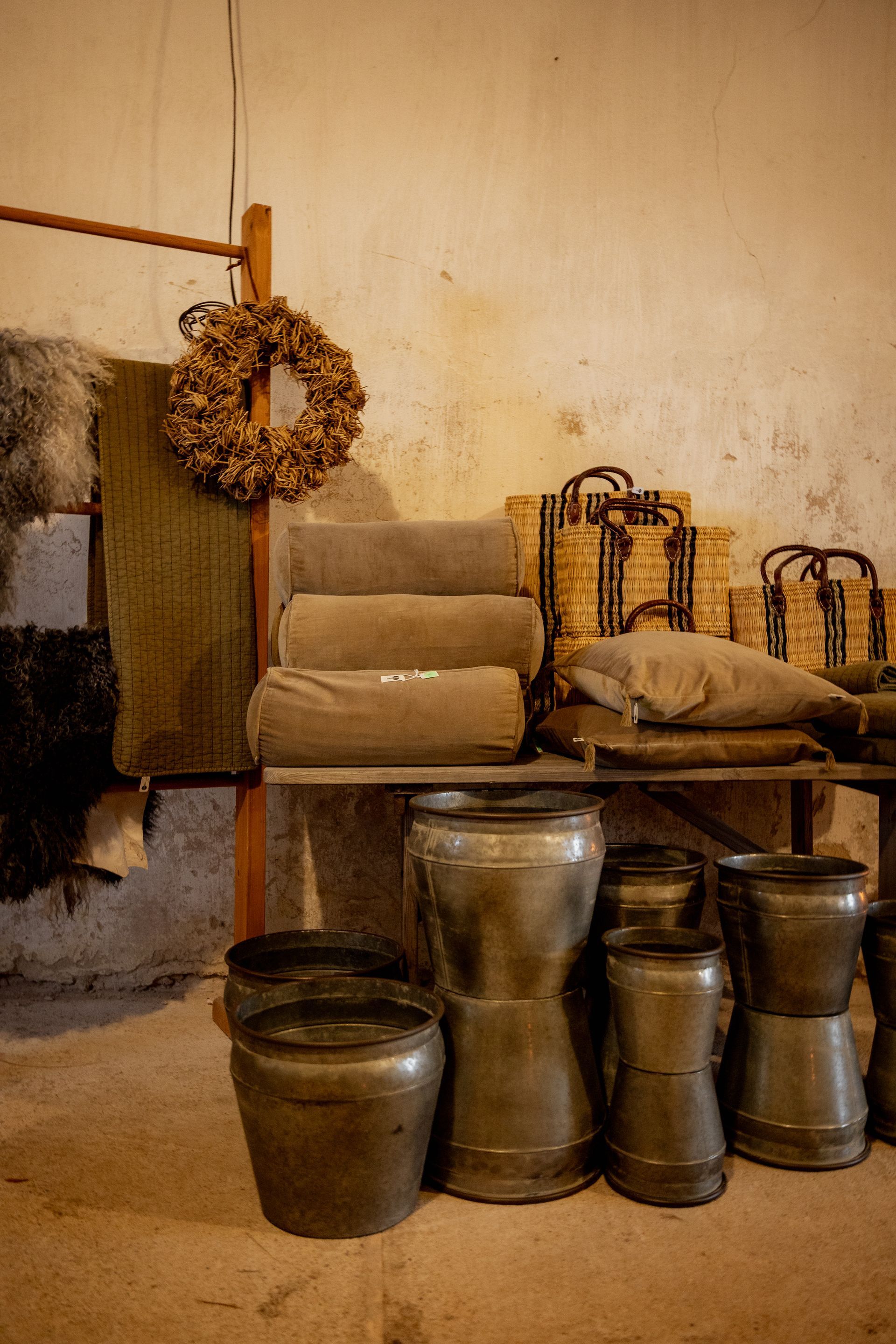 Three squeeze bottles with yellow liquids, against a brick wall.
