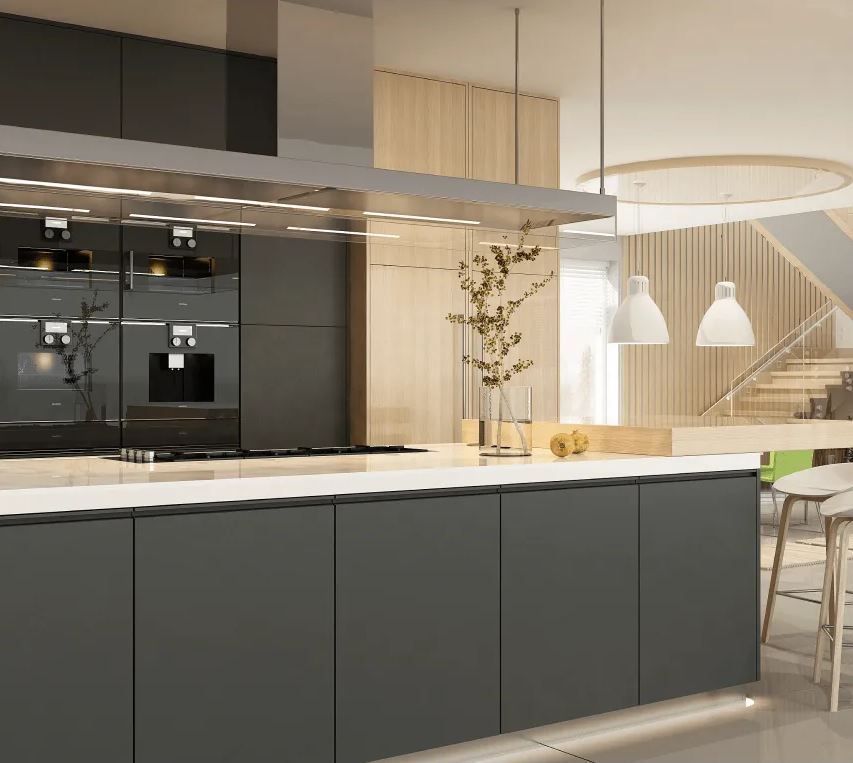 Modern kitchen interior with dark cabinetry, white island, pendant lights, and dining area