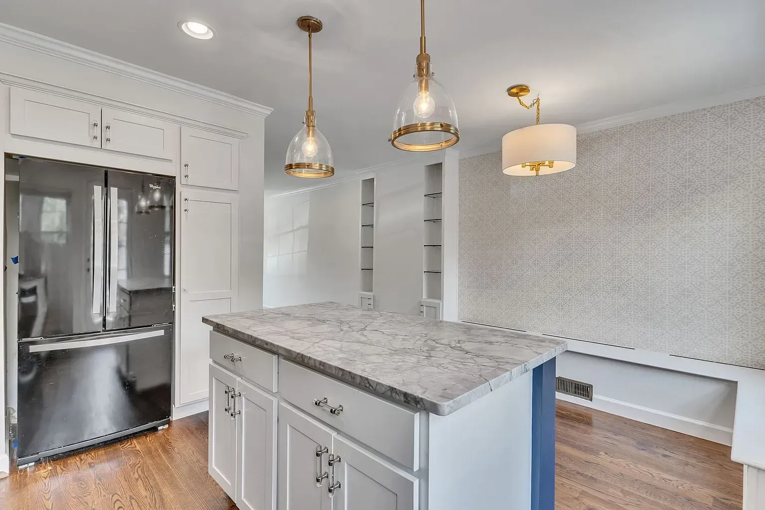 There is a large island in the middle of the kitchen.