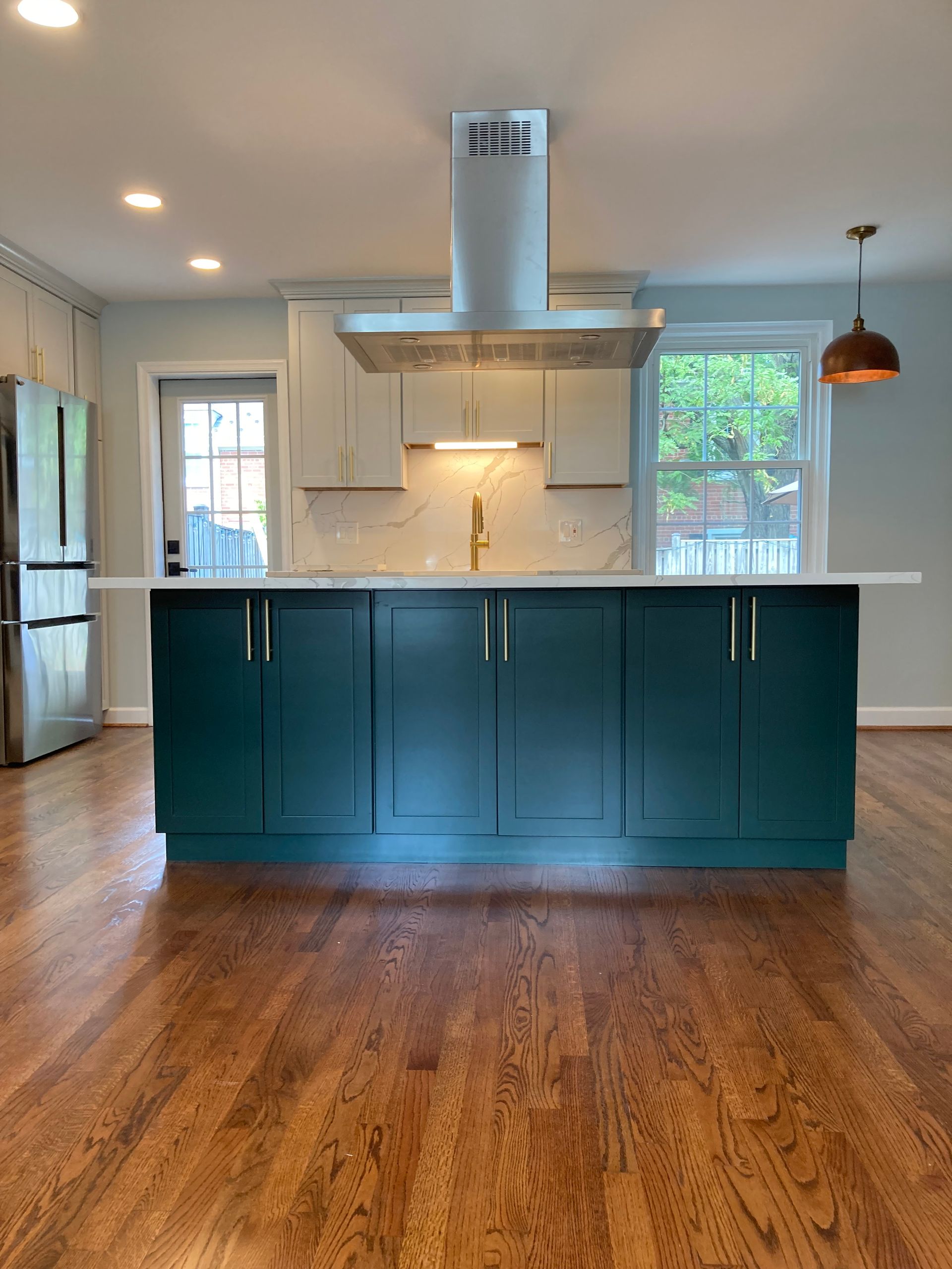 A kitchen with a large island in the middle of the room.