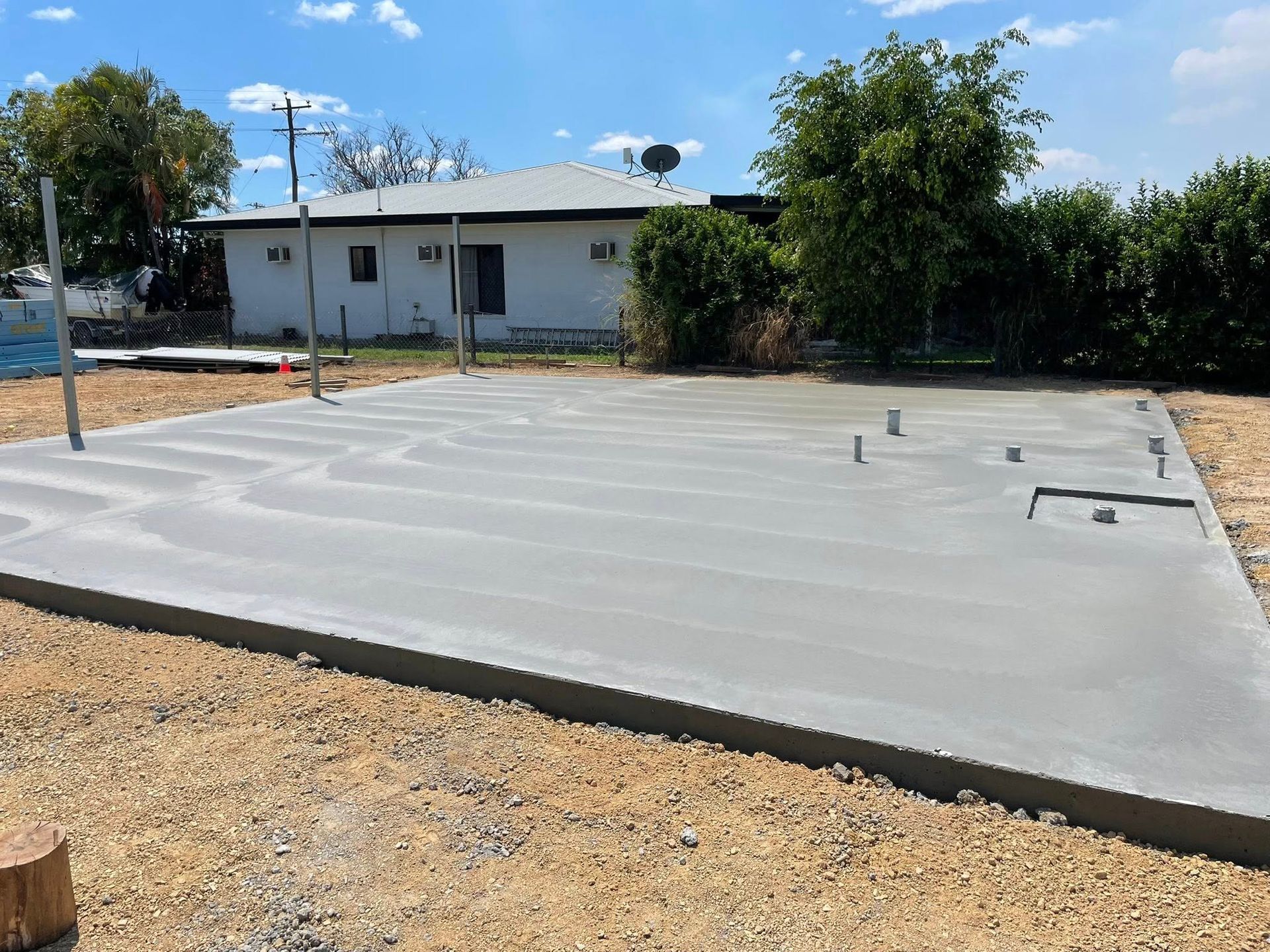 Newly Poured Concrete Slab in Front of a White House — Sun Co Concrete And Construction in Dimbulah, QLD