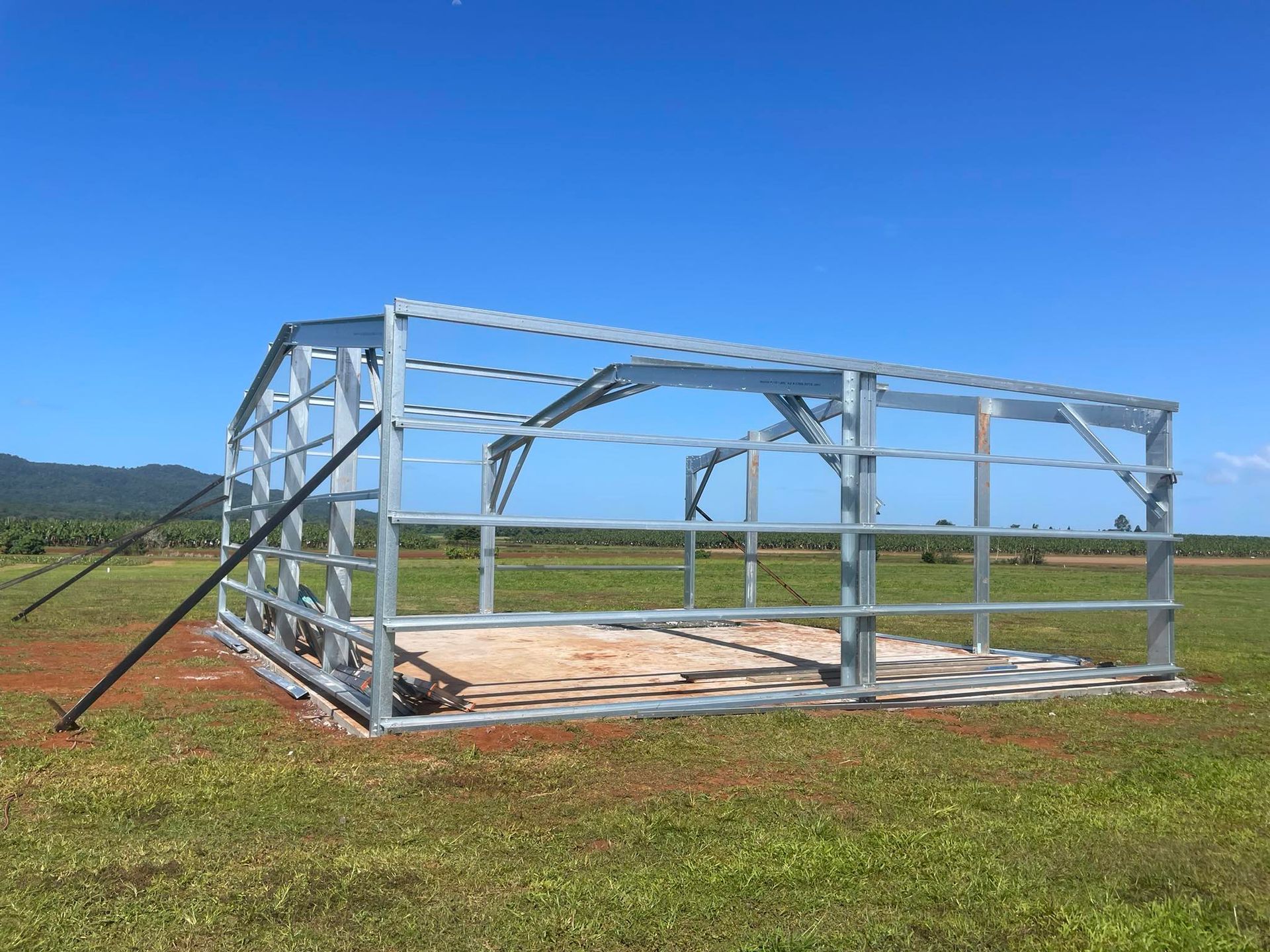 Steel Frame of a Building Under Construction on a Grassy Field — Sun Co Concrete And Construction in Dimbulah, QLD
