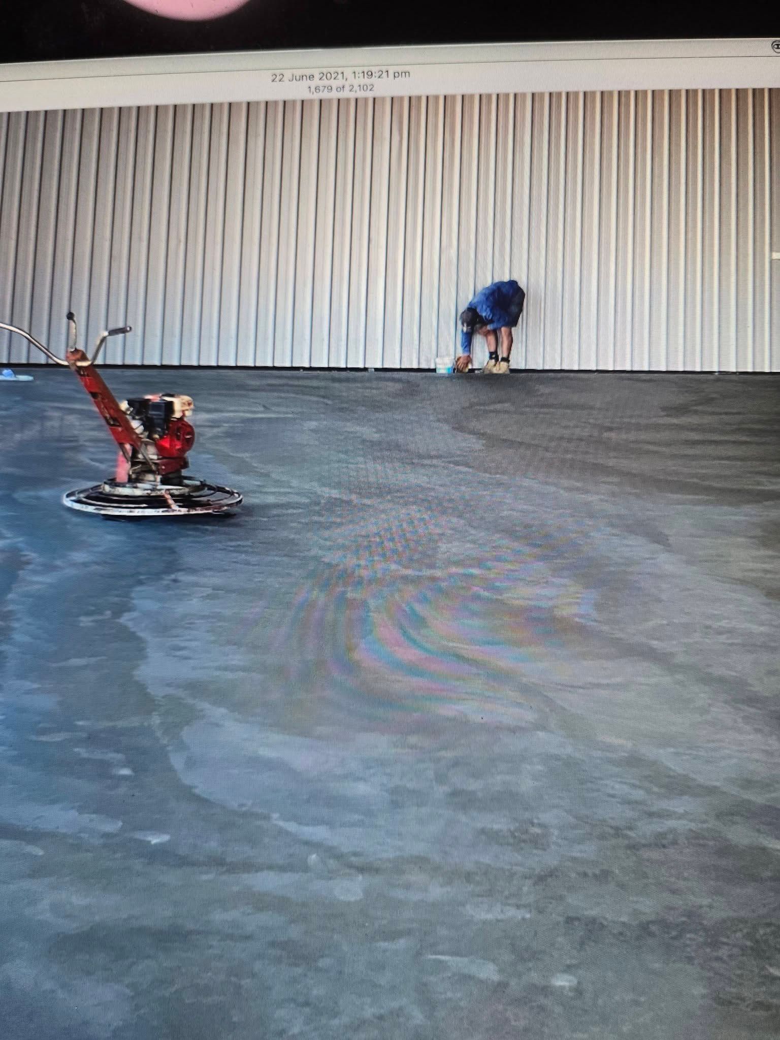 Person Working on a Concrete Floor With a Power Trowel — Sun Co Concrete And Construction in Dimbulah, QLD