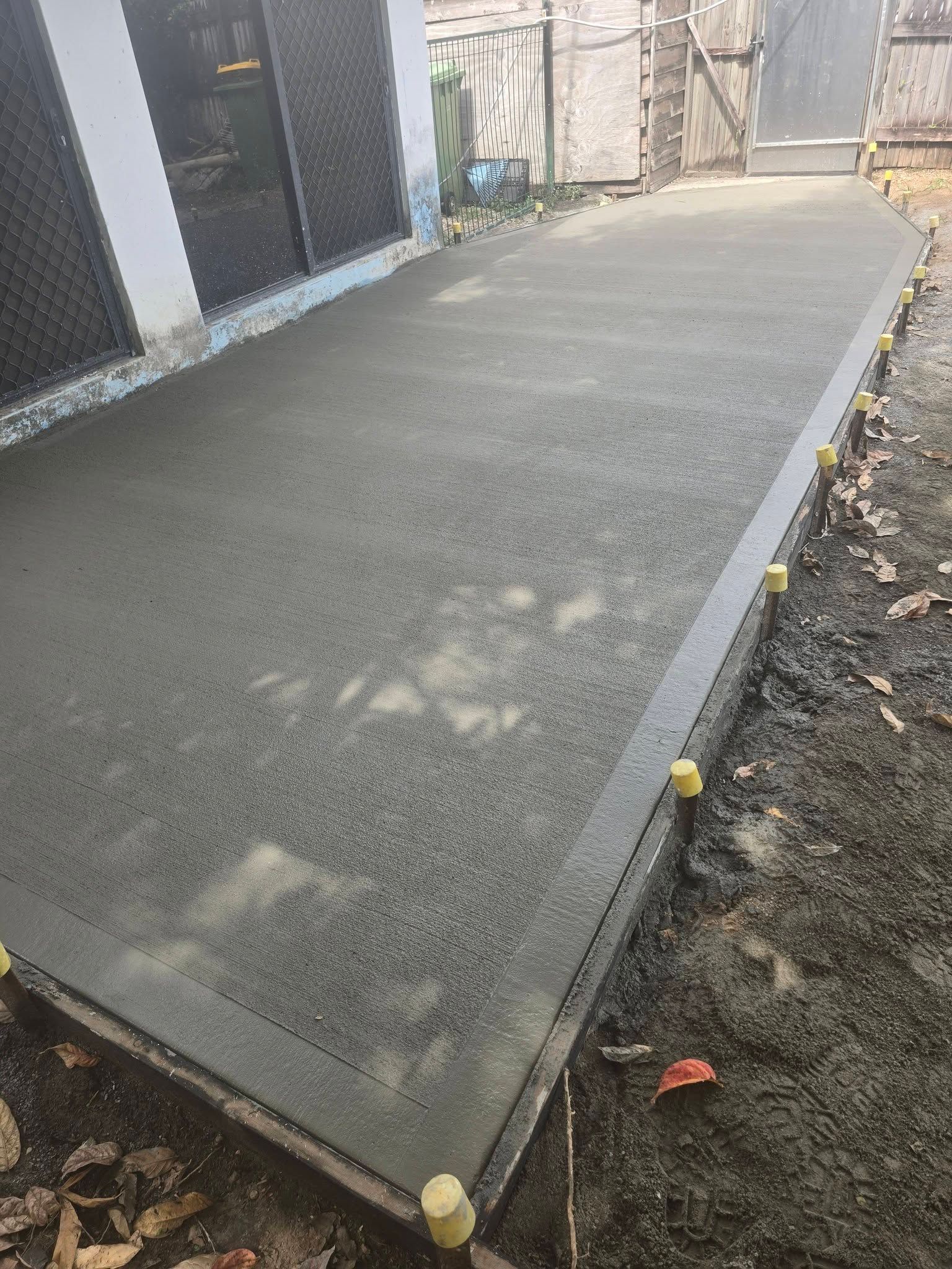 Newly Poured Concrete Walkway Next to a Building — Sun Co Concrete And Construction in Dimbulah, QLD