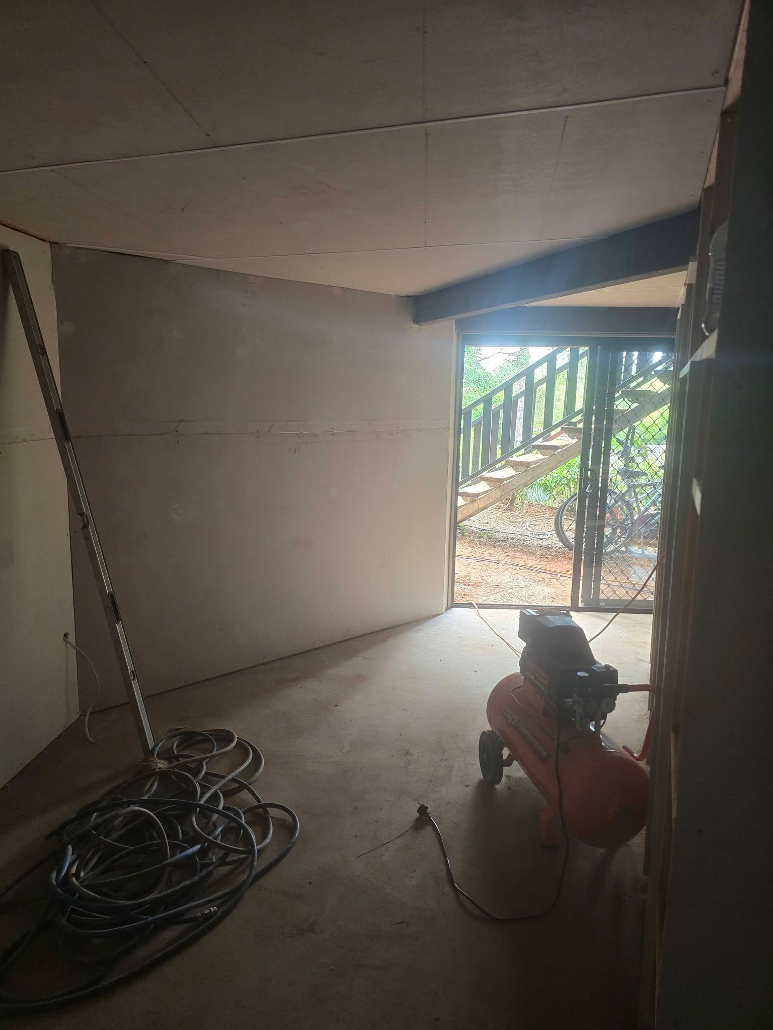 Interior Room With Unfinished Drywall and an Open Doorway — Sun Co Concrete And Construction in Dimbulah, QLD