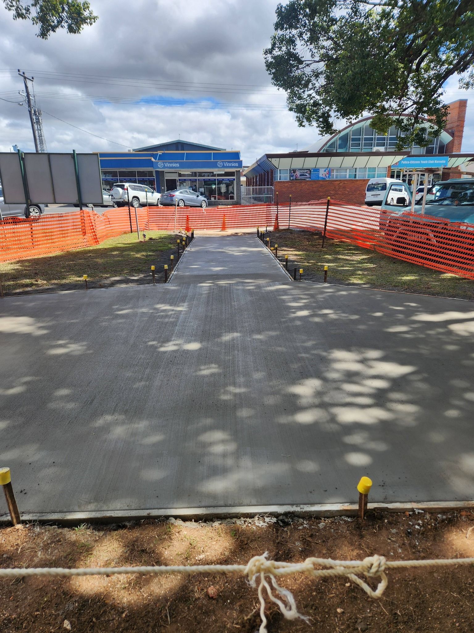 Newly Poured Concrete Pathway With Orange Construction Fencing — Sun Co Concrete And Construction in Dimbulah, QLD