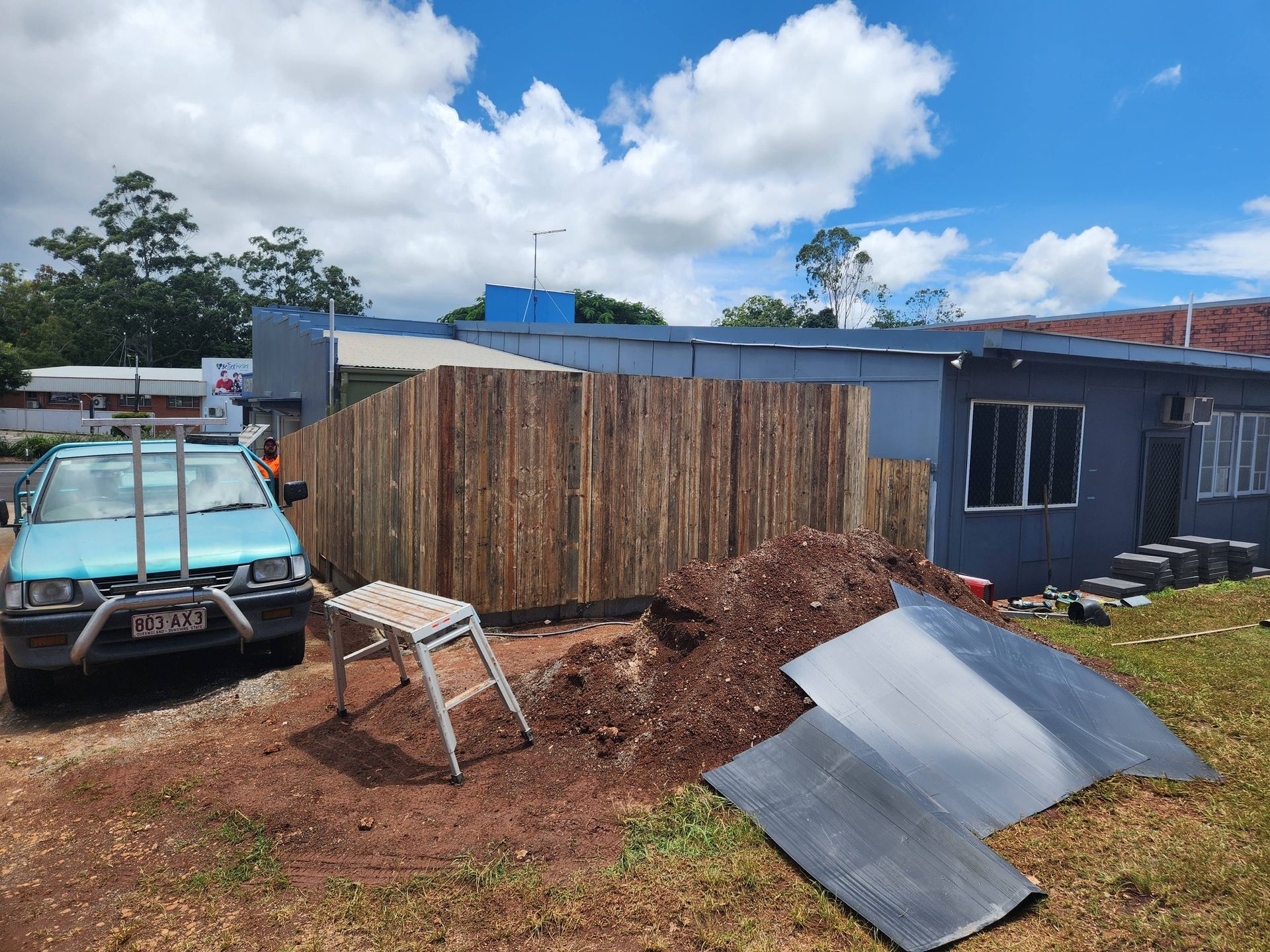 Light Blue Truck Near a New Wooden Fence — Sun Co Concrete And Construction in Dimbulah, QLD
