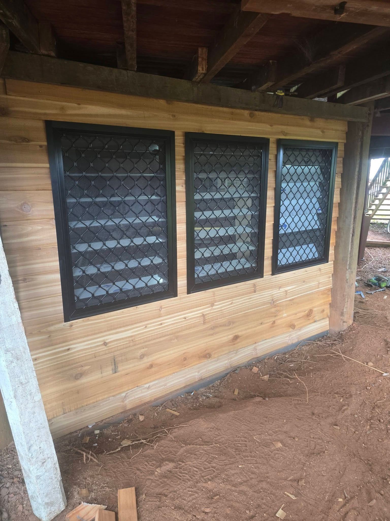 Exterior Wall With Three Security Screen Windows in a Wooden Structure — Sun Co Concrete And Construction in Dimbulah, QLD