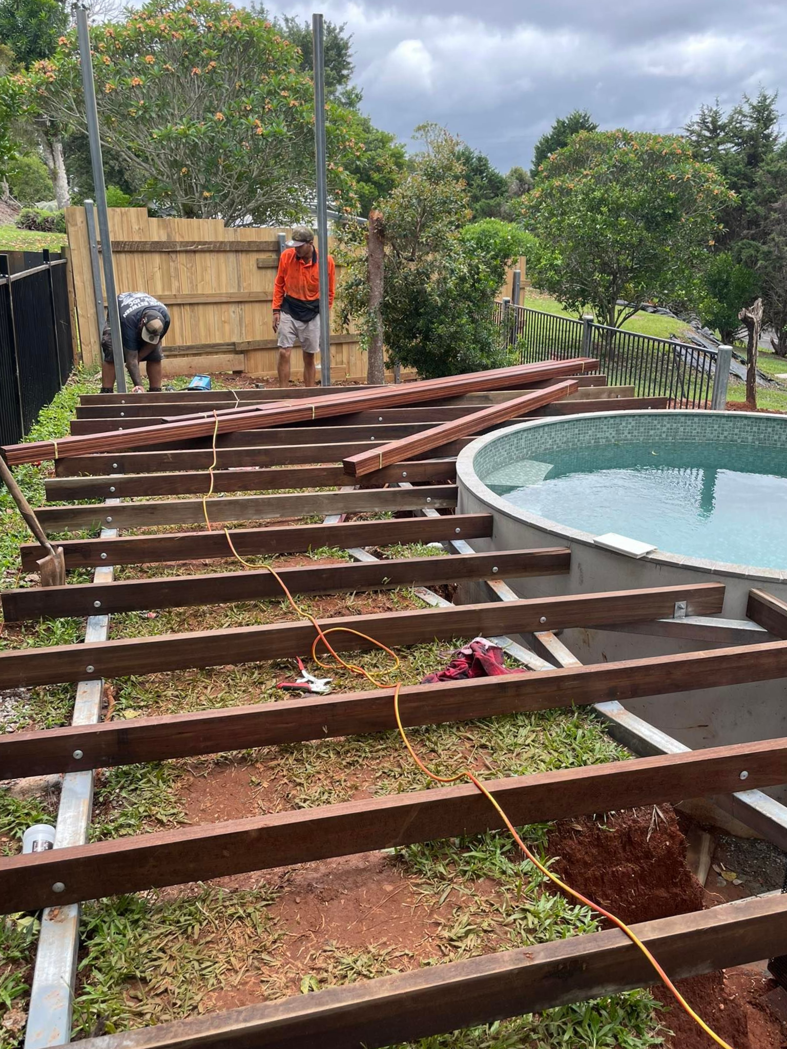 Construction of a Wooden Deck Near a Circular Pool — Sun Co Concrete And Construction in Dimbulah, QLD