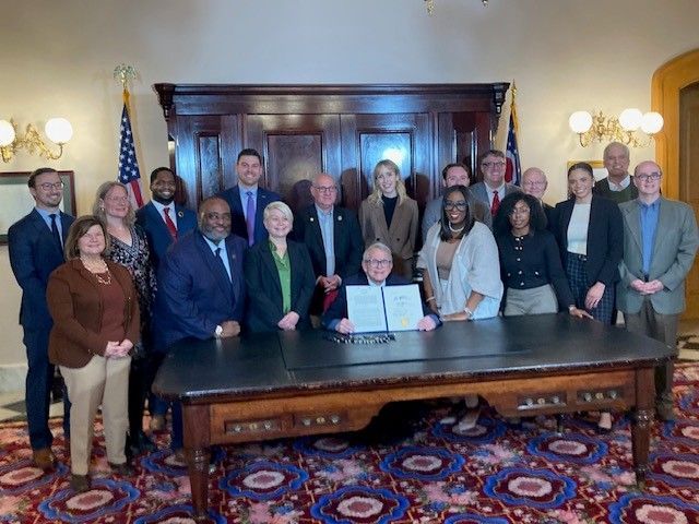 Advocates and legislators gather with Governor DeWine for the signing of HB 29.