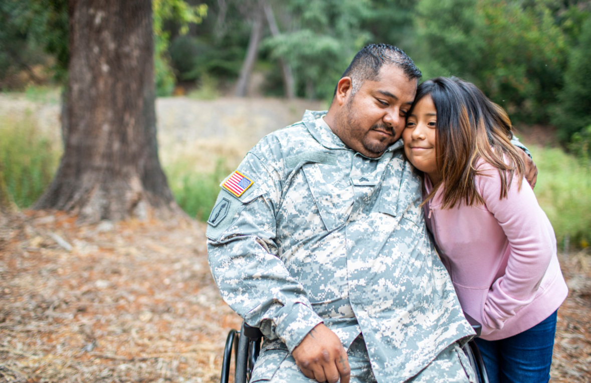 Veteran in wheelchair hugs daughter