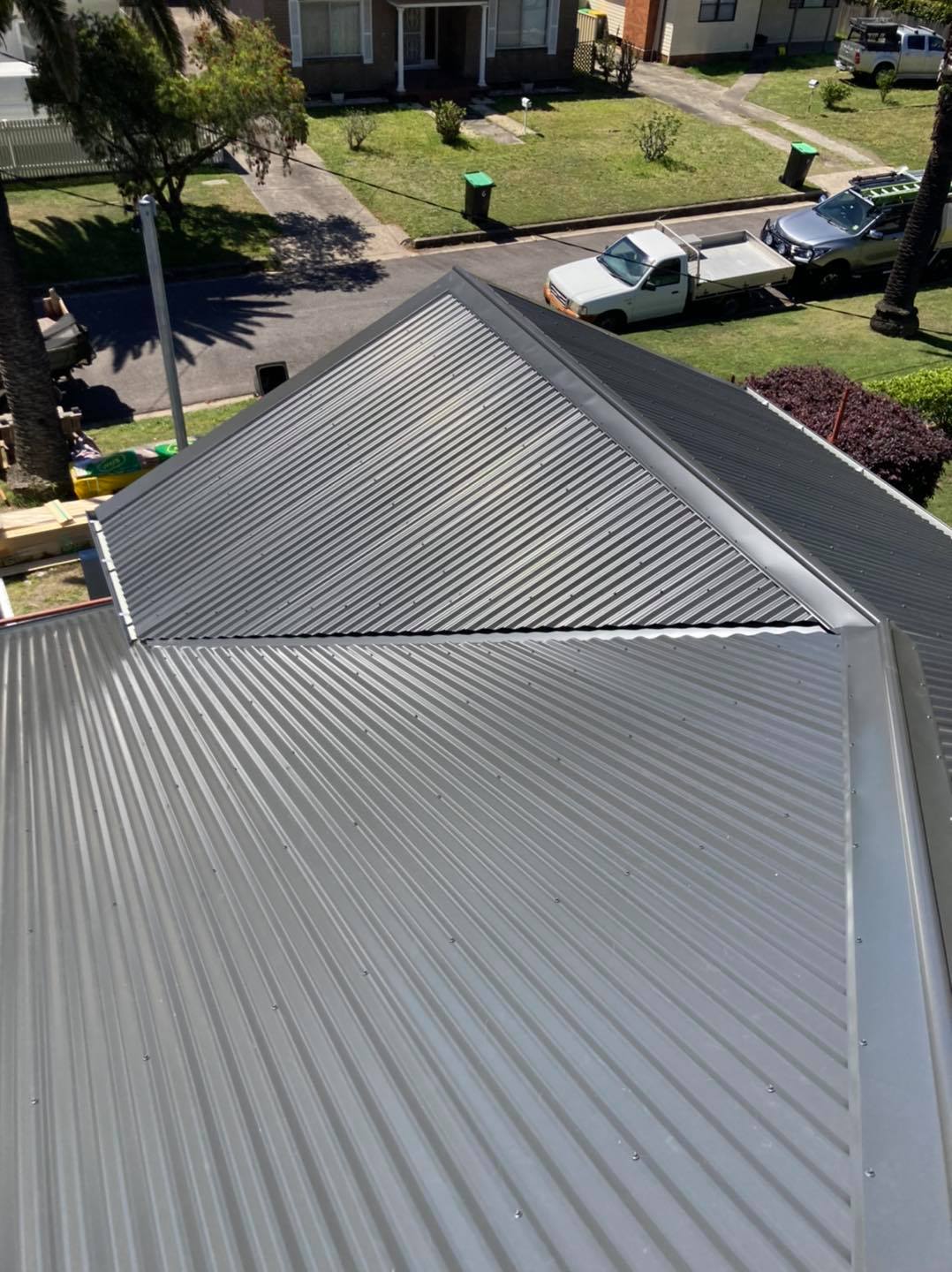 An aerial view of a roof of a house in a residential area.