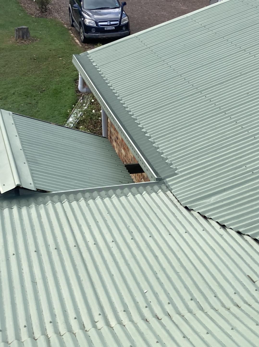 A car is parked on the roof of a house