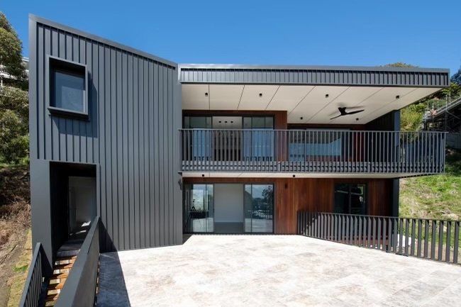 A large house with a balcony and stairs on the side of it