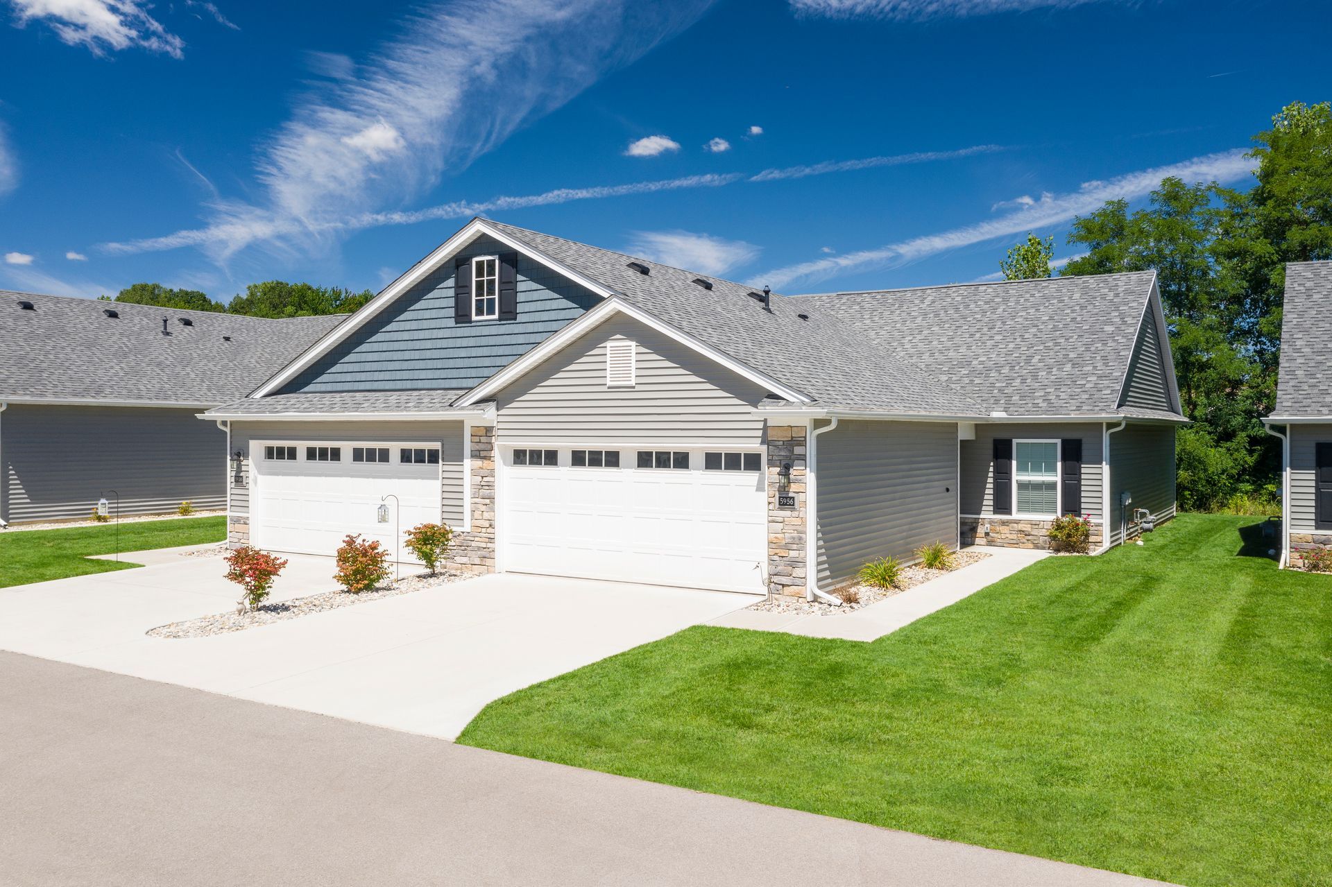 Photo of a duplex, with garages and driveways