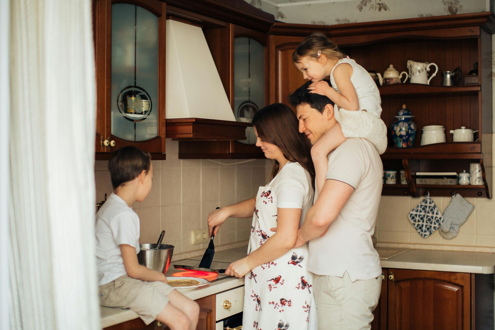A family is cooking together in a kitchen.