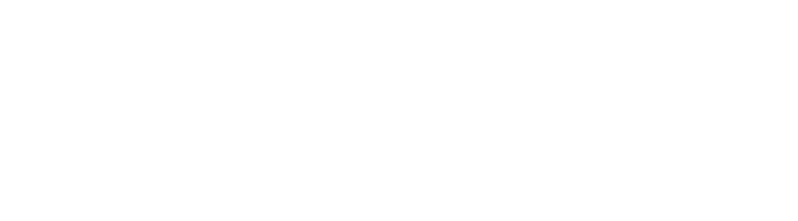 A group of people wearing lab coats and safety goggles work together in a bright, modern chemistry laboratory.