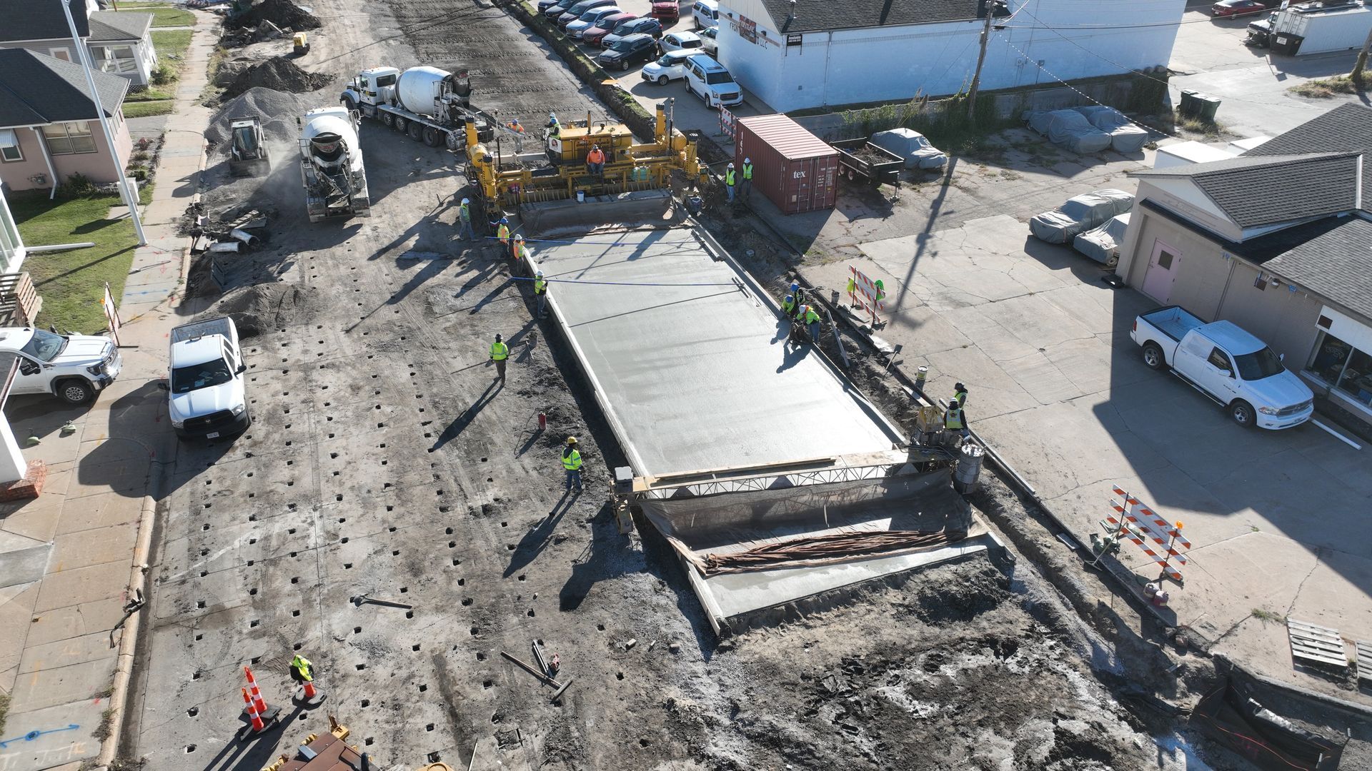 CL Construction paving crew laying fresh concrete on Adams Street in Lincoln, Nebraska, as part of the LTU street rehabilitation project, with a Gomaco Paver machine