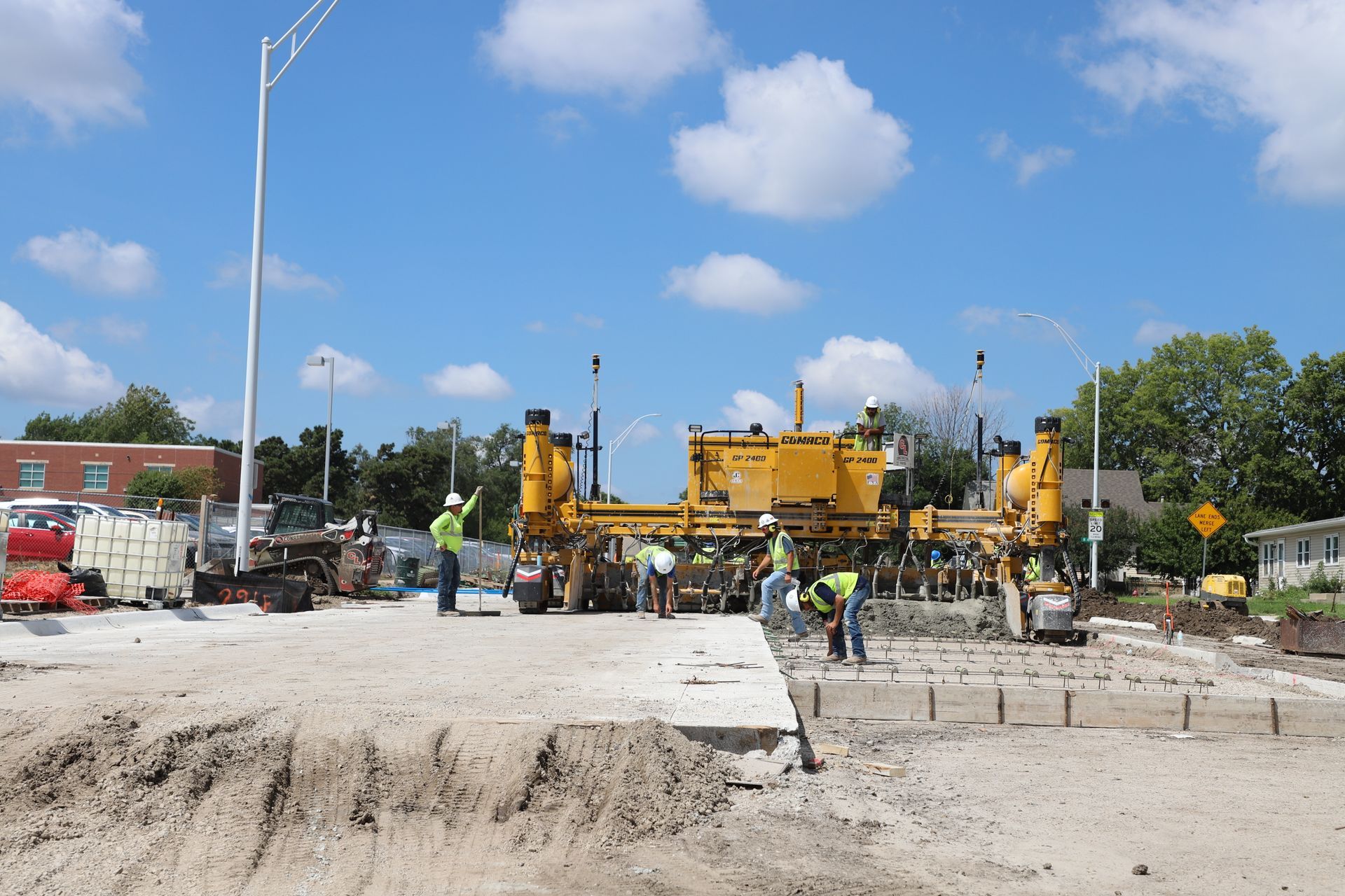 CL Construction paving crew laying fresh concrete on Adams Street in Lincoln, Nebraska, as part of the LTU street rehabilitation project, with a Gomaco Paver machine