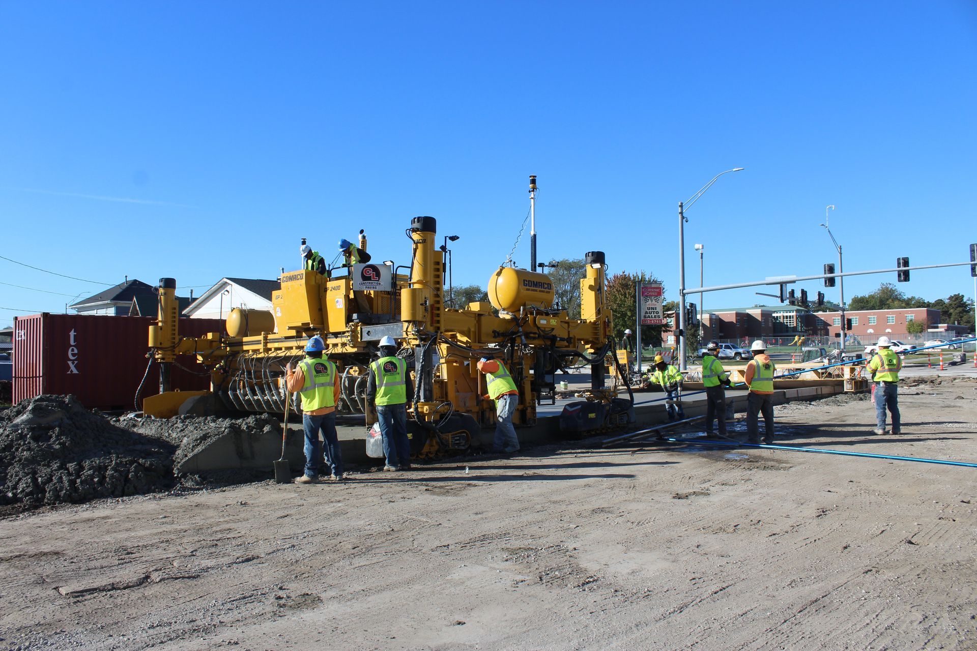 CL Construction paving crew laying fresh concrete on Adams Street in Lincoln, Nebraska, as part of the LTU street rehabilitation project, with a Gomaco Paver machine