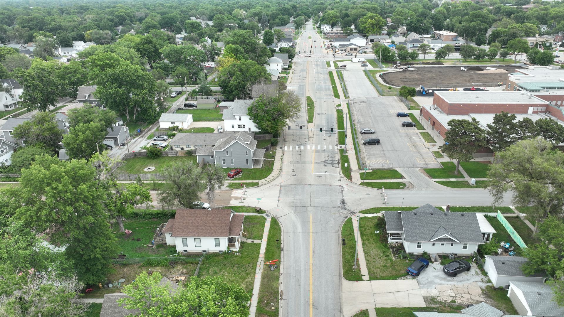 CL Construction paving crew laying fresh concrete on Adams Street in Lincoln, Nebraska, as part of the LTU street rehabilitation project, with a Gomaco Paver machine Aerial City View