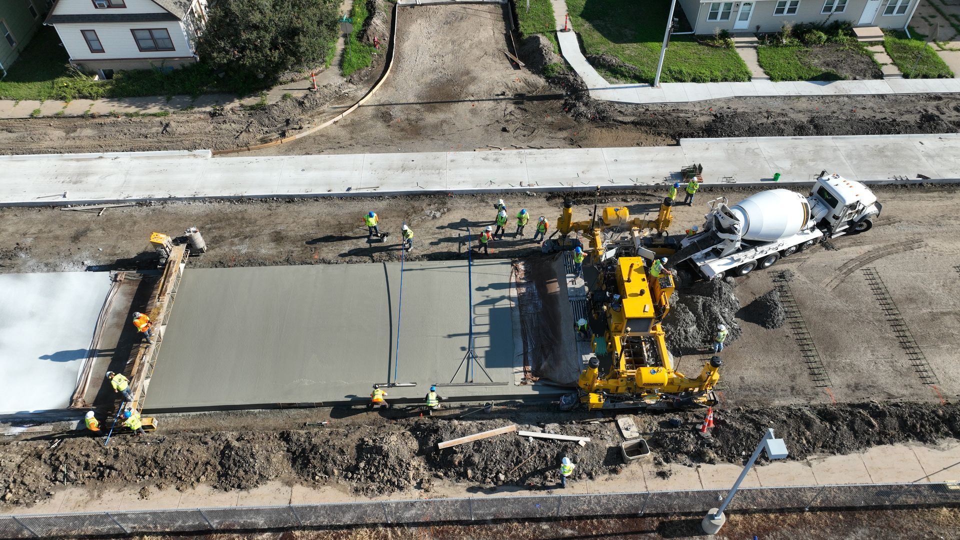 CL Construction paving crew laying fresh concrete on Adams Street in Lincoln, Nebraska, as part of the LTU street rehabilitation project, with a Gomaco Paver machine