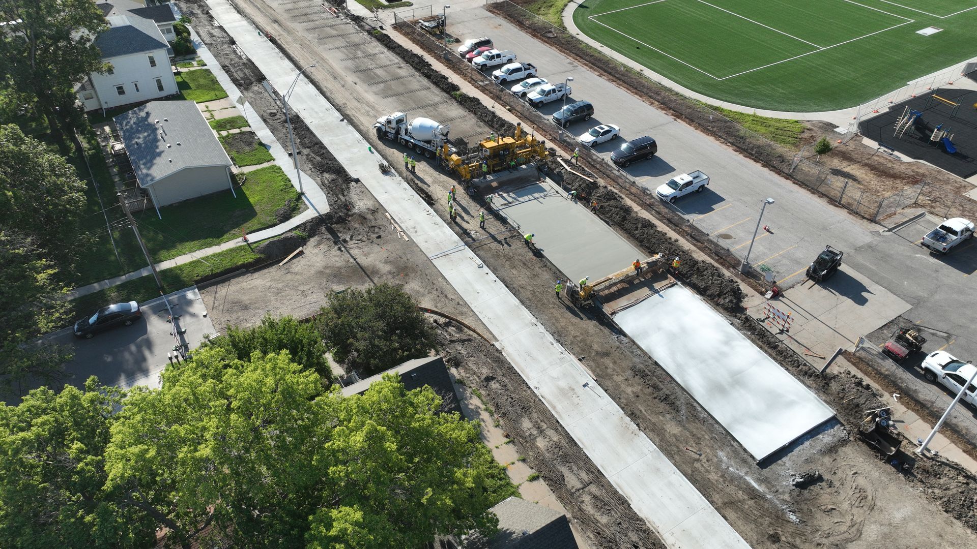CL Construction paving crew laying fresh concrete on Adams Street in Lincoln, Nebraska, as part of the LTU street rehabilitation project, with a Gomaco Paver machine