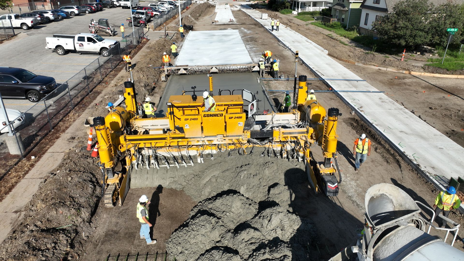 CL Construction paving crew laying fresh concrete on Adams Street in Lincoln, Nebraska, as part of the LTU street rehabilitation project, with a Gomaco Paver machine