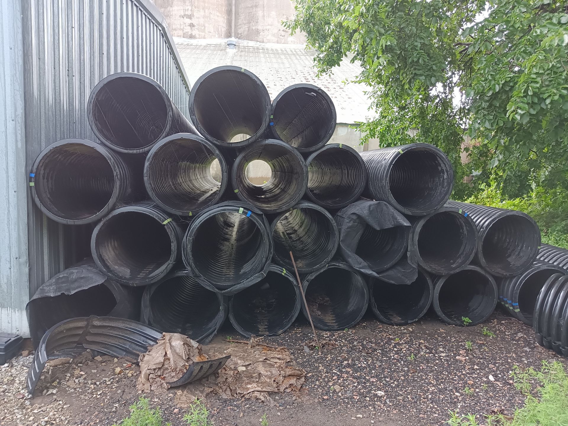 A pile of black pipes stacked on top of each other.