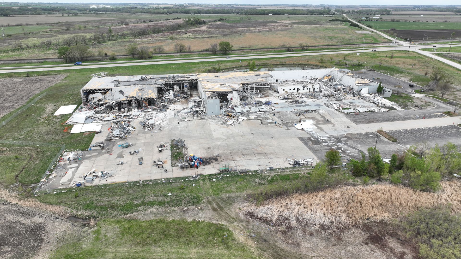 CL Construction crew using excavators to demolish and remove debris from the tornado-destroyed Garner Industries warehouse in Lincoln, Nebraska