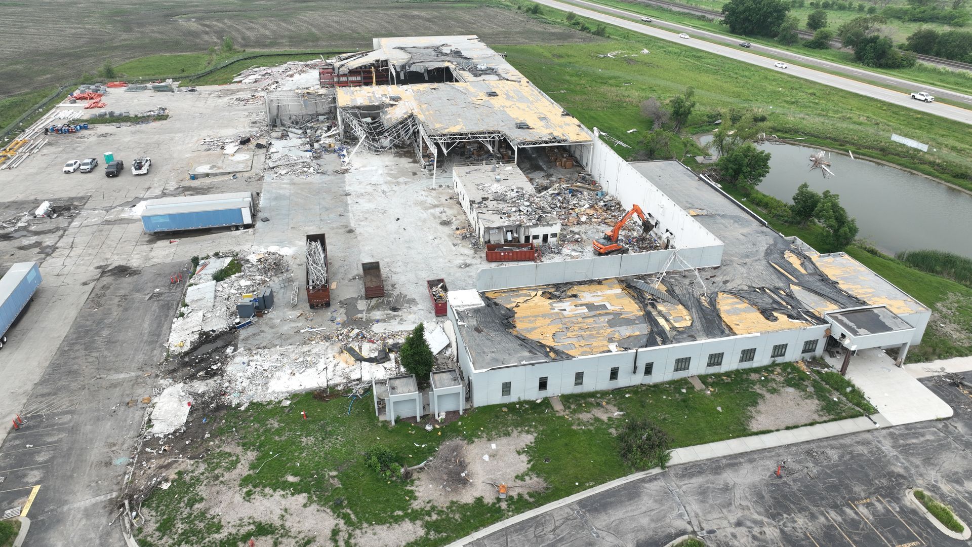 CL Construction crew using excavators to demolish and remove debris from the tornado-destroyed Garner Industries warehouse in Lincoln, Nebraska