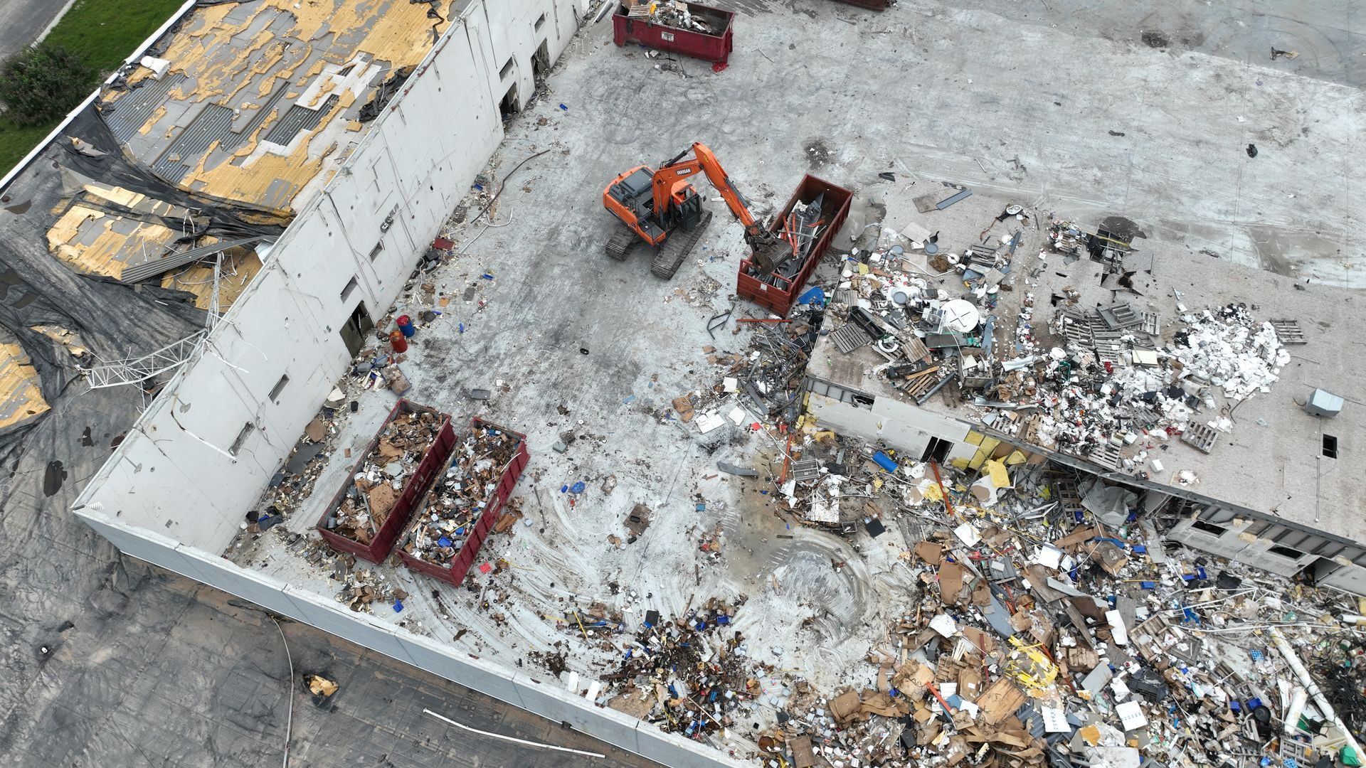 CL Construction crew using excavators to demolish and remove debris from the tornado-destroyed Garner Industries warehouse in Lincoln, Nebraska