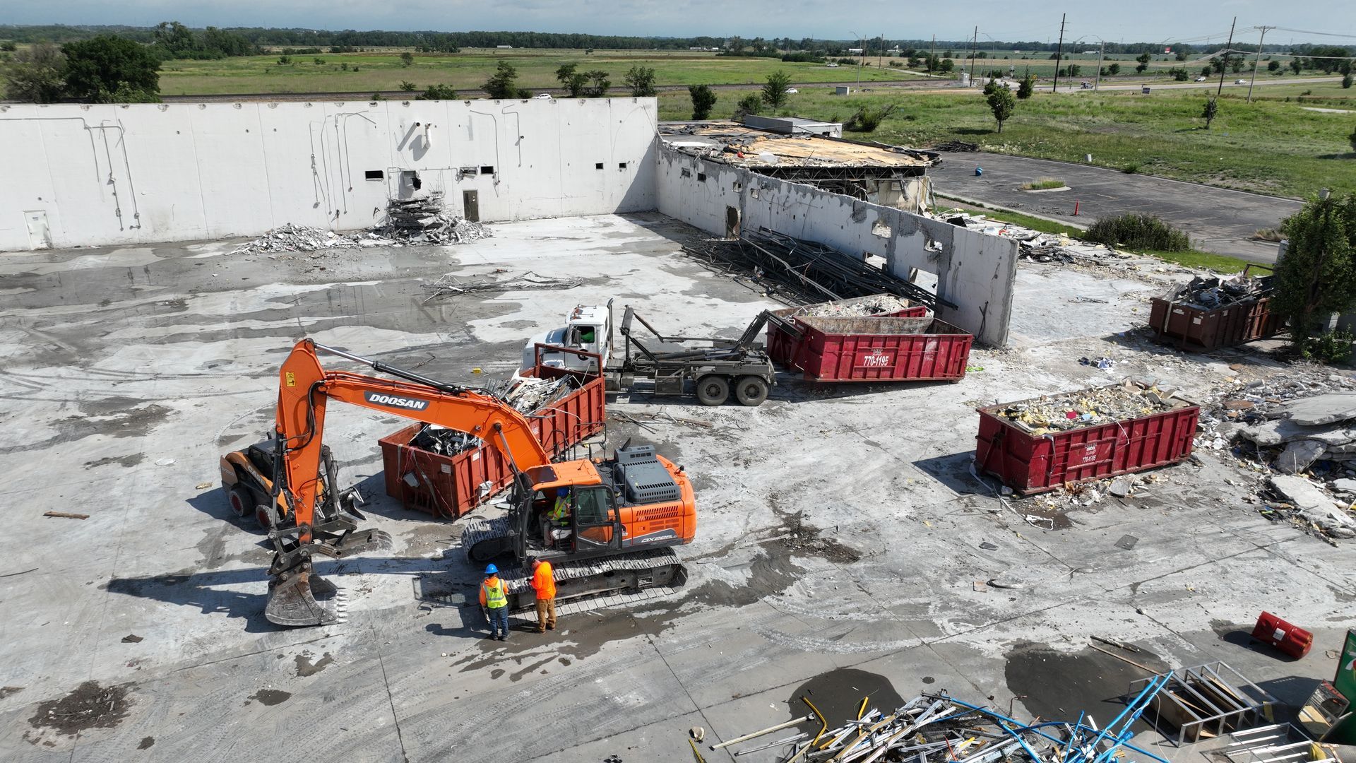 CL Construction crew using excavators to demolish and remove debris from the tornado-destroyed Garner Industries warehouse in Lincoln, Nebraska
