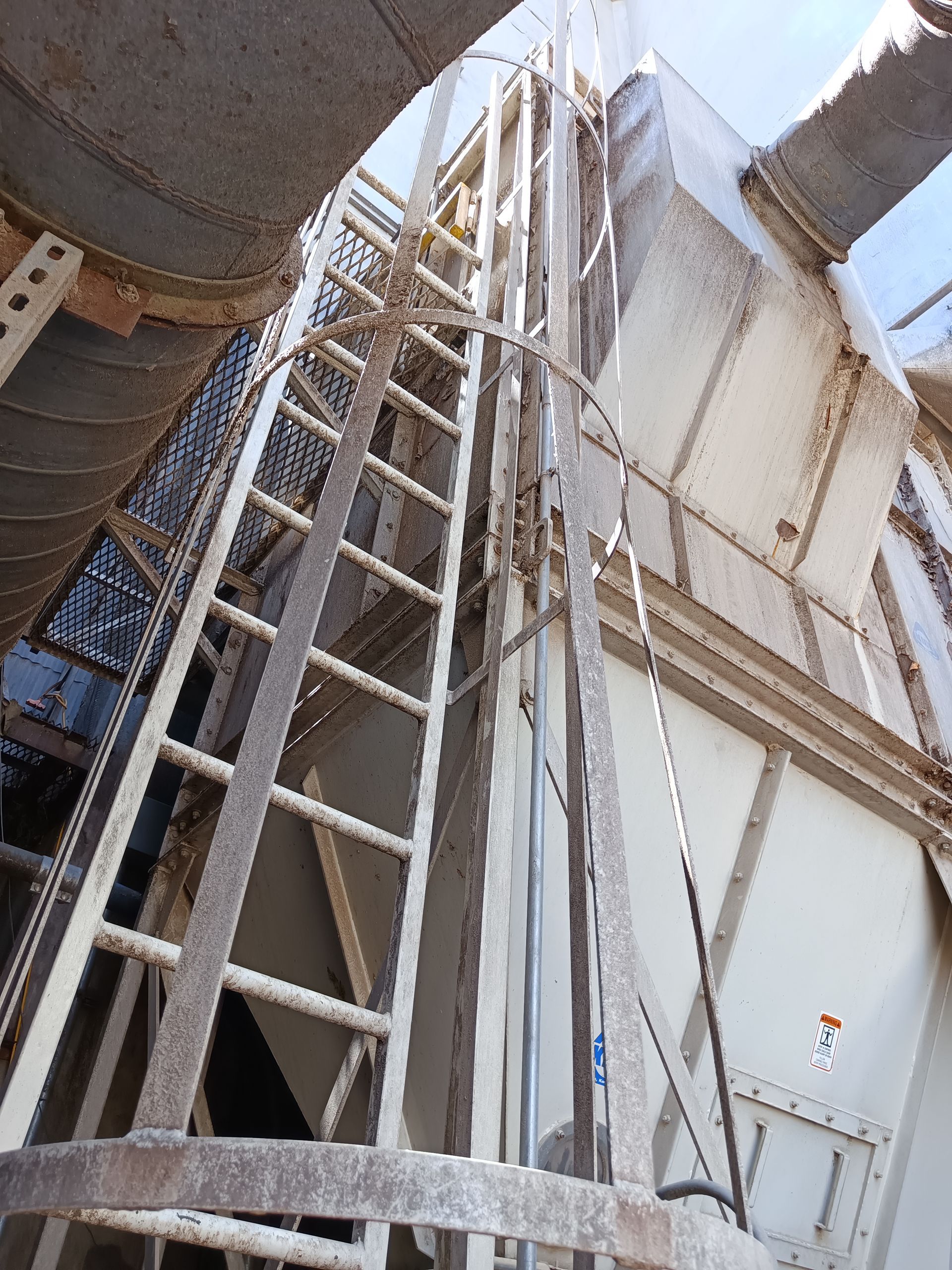 A ladder is going up to the top of a building