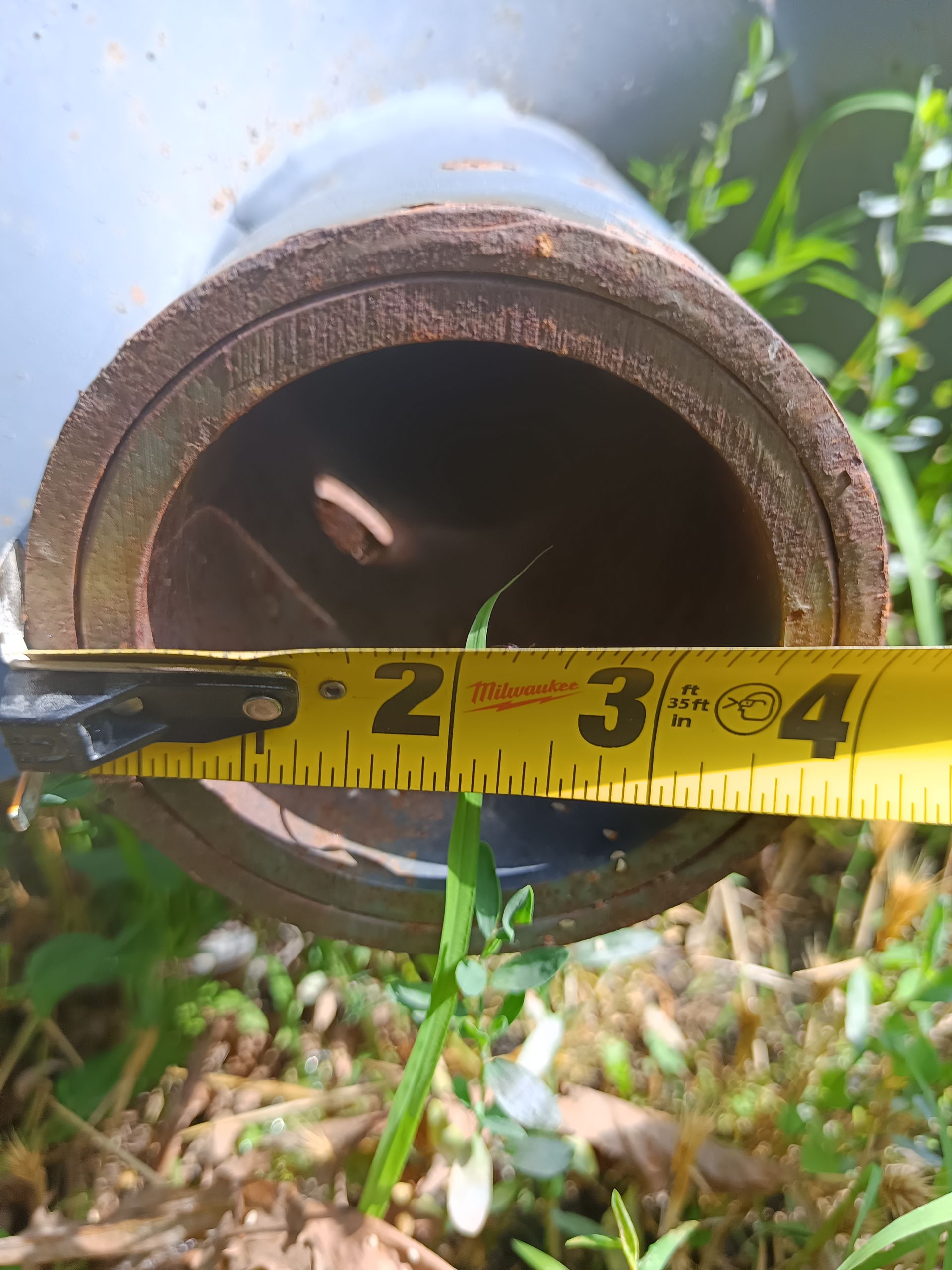 A measuring tape is being used to measure a pipe
