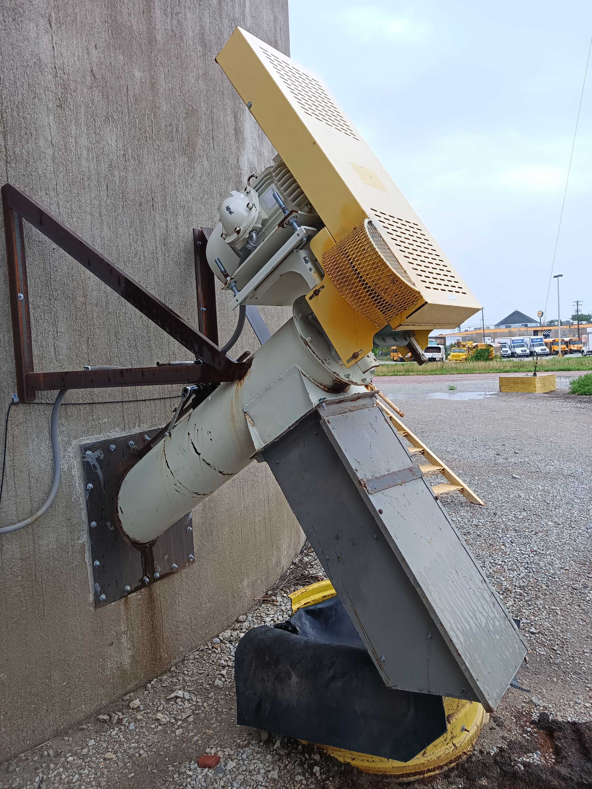 A machine is sitting on the ground next to a wall.