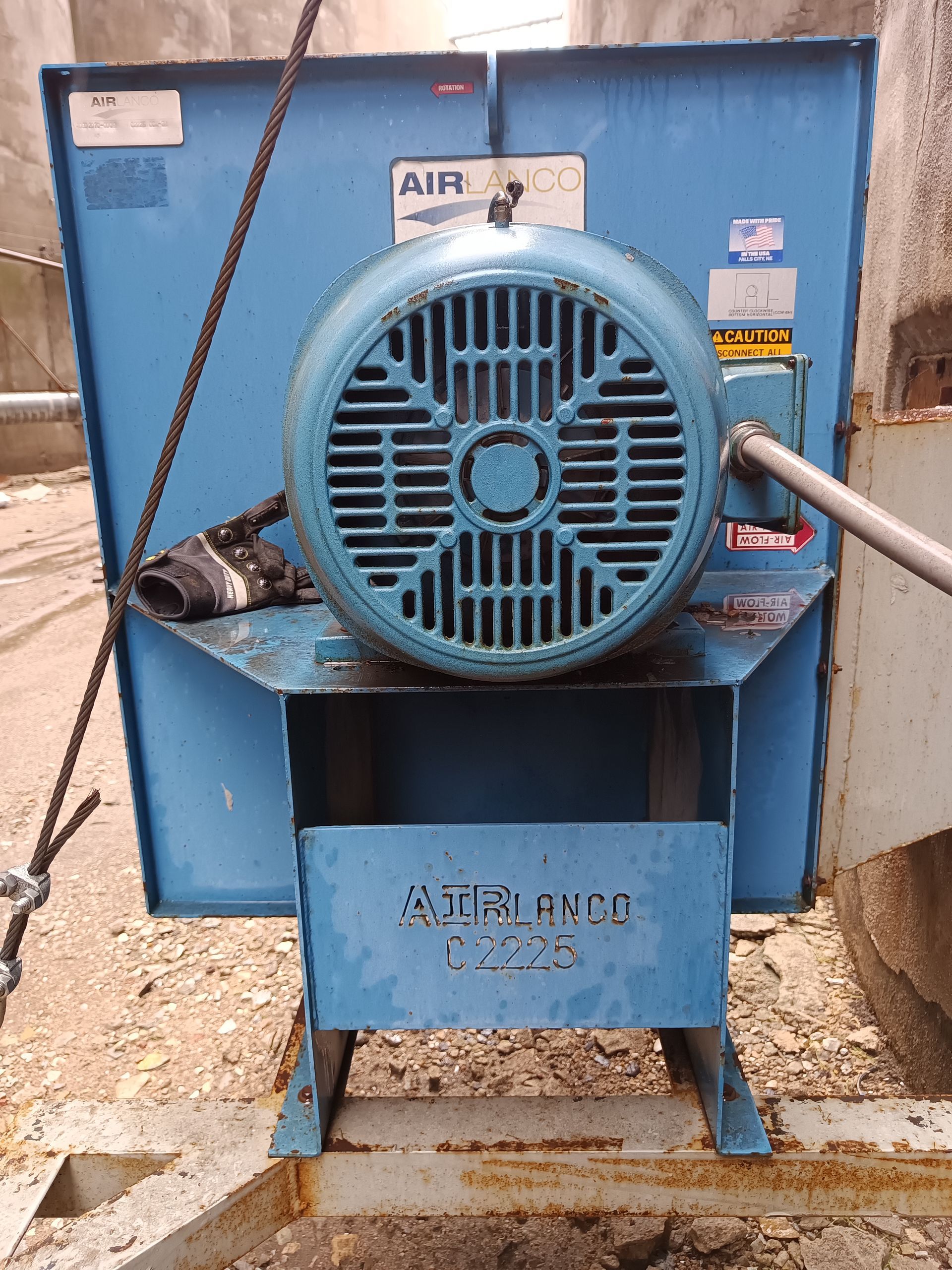 A blue fan with a motor attached to it